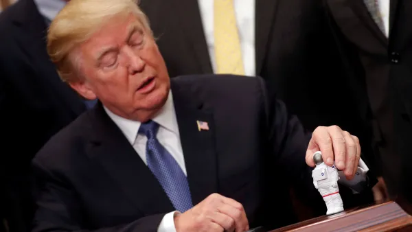 U.S. President Donald Trump holds a space astronaut toy as he participates in a signing ceremony for Space Policy Directive at the White House in Washington D.C.