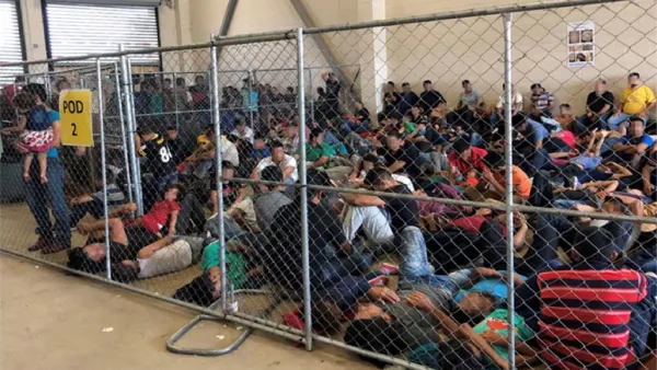 An overcrowded fenced area holding families at a Border Patrol station is seen in McAllen