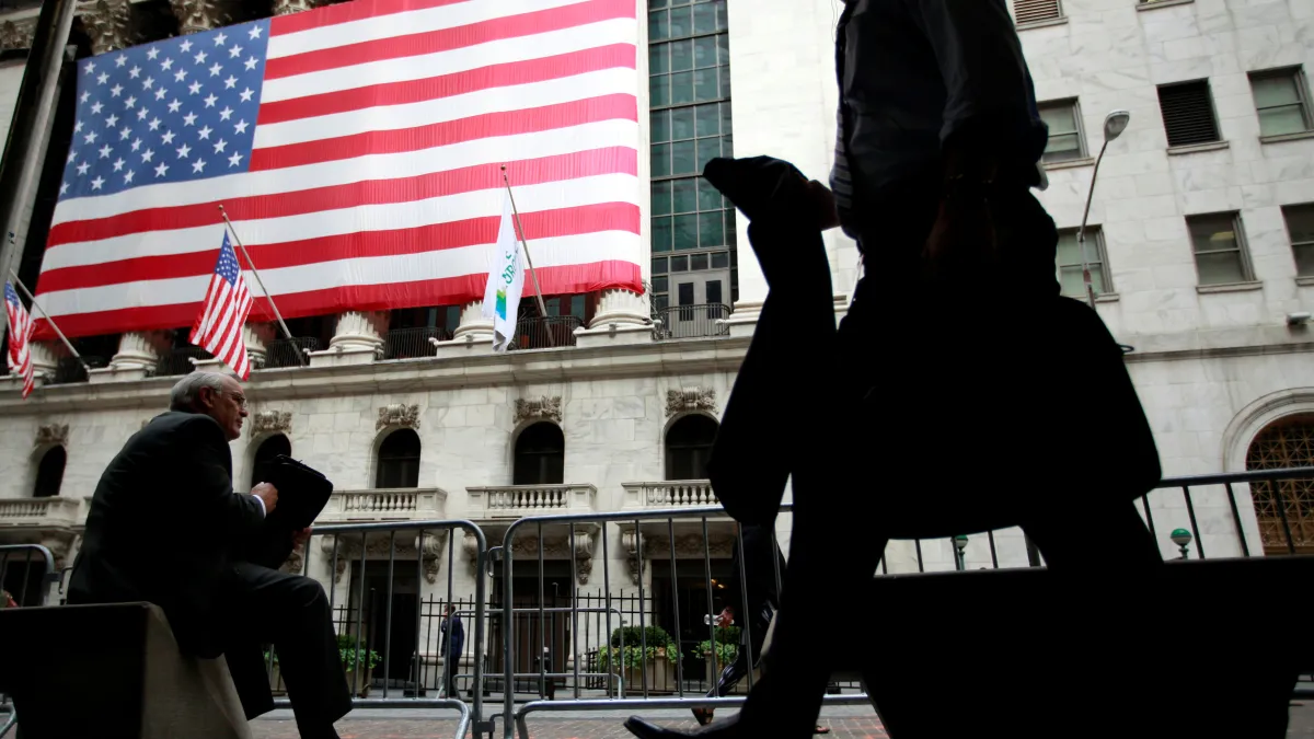 FILE PHOTO -  Morning commuters are seen outside the New York Stock Exchange