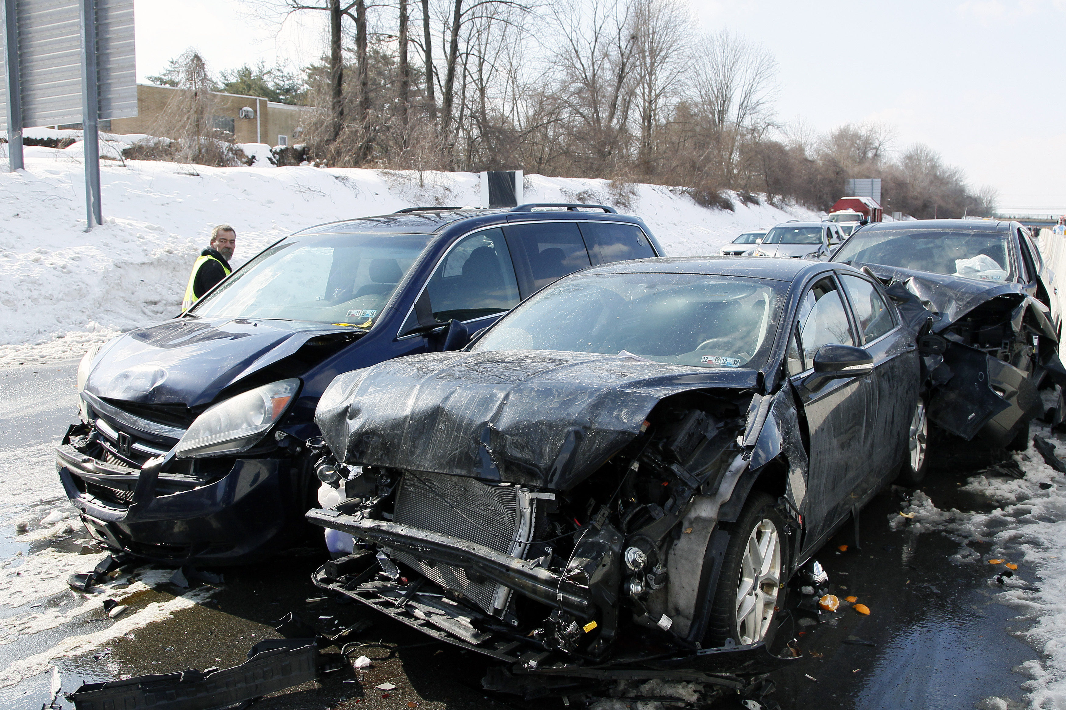 Smashed cars litter at the scene of an earlier multi-car and truck pile up the Pennsylvania Turnpike near the Bensalem interchange in Pennsylvania