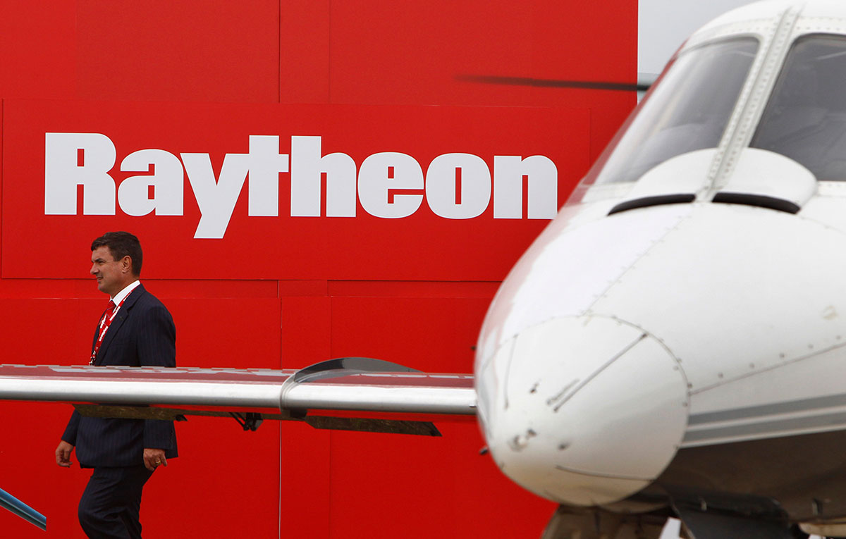 A man walks past the Raytheon exhibition during the Australian International Airshow in Melbourne