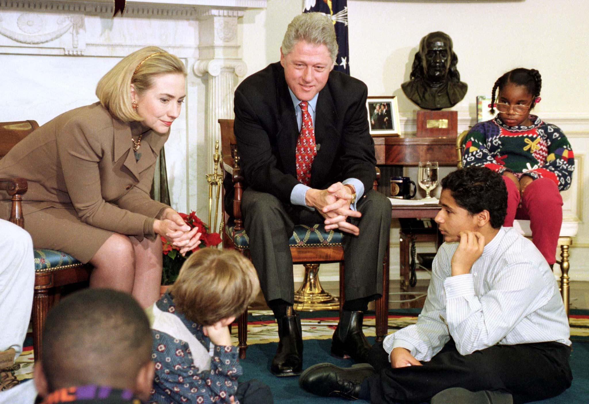 President Clinton and first lady Hillary Clinton talk with children awaiting adoption after the pres..