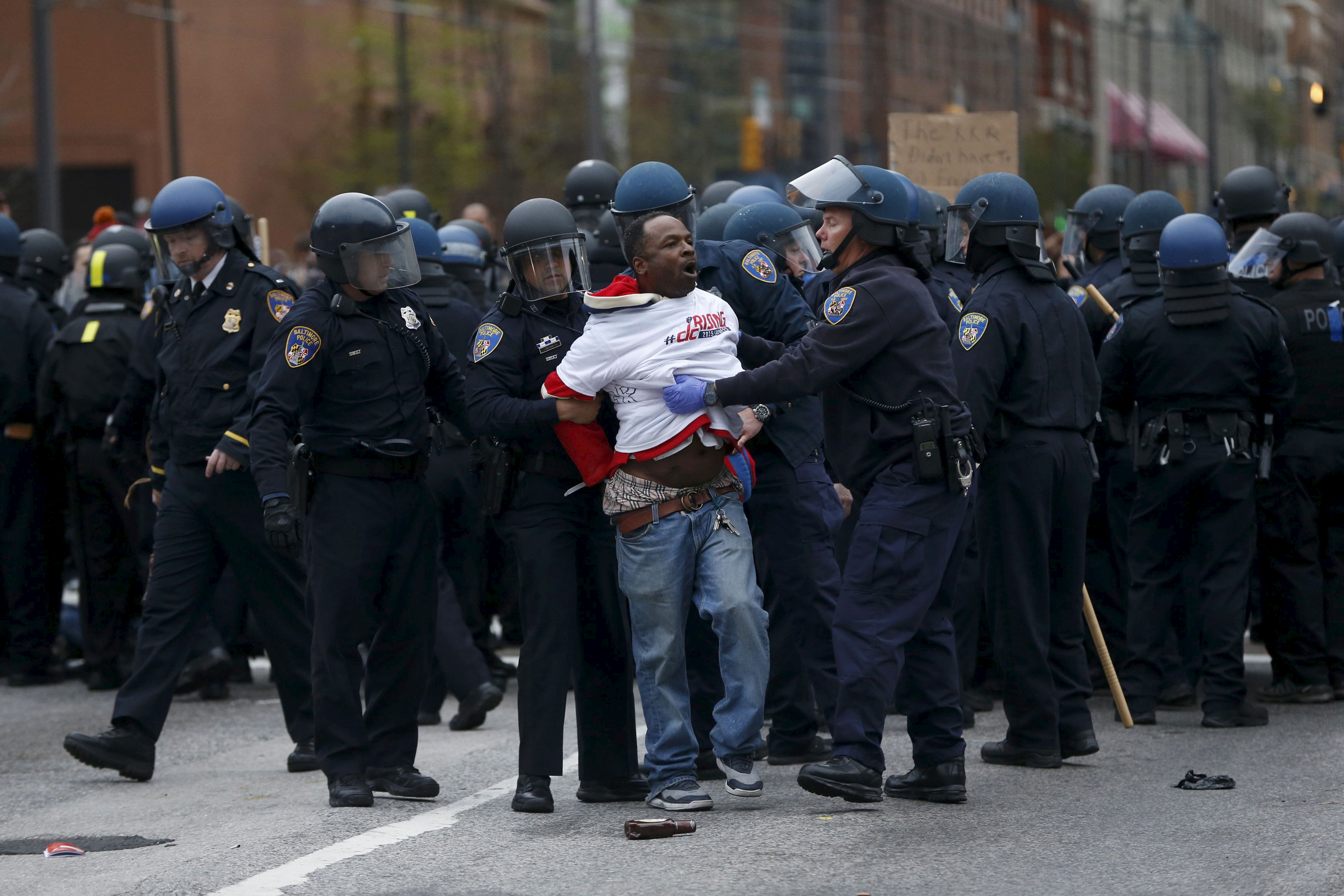 Police detain a protester at a rally to protest the death of Freddie Gray who died following an arrest in Baltimore