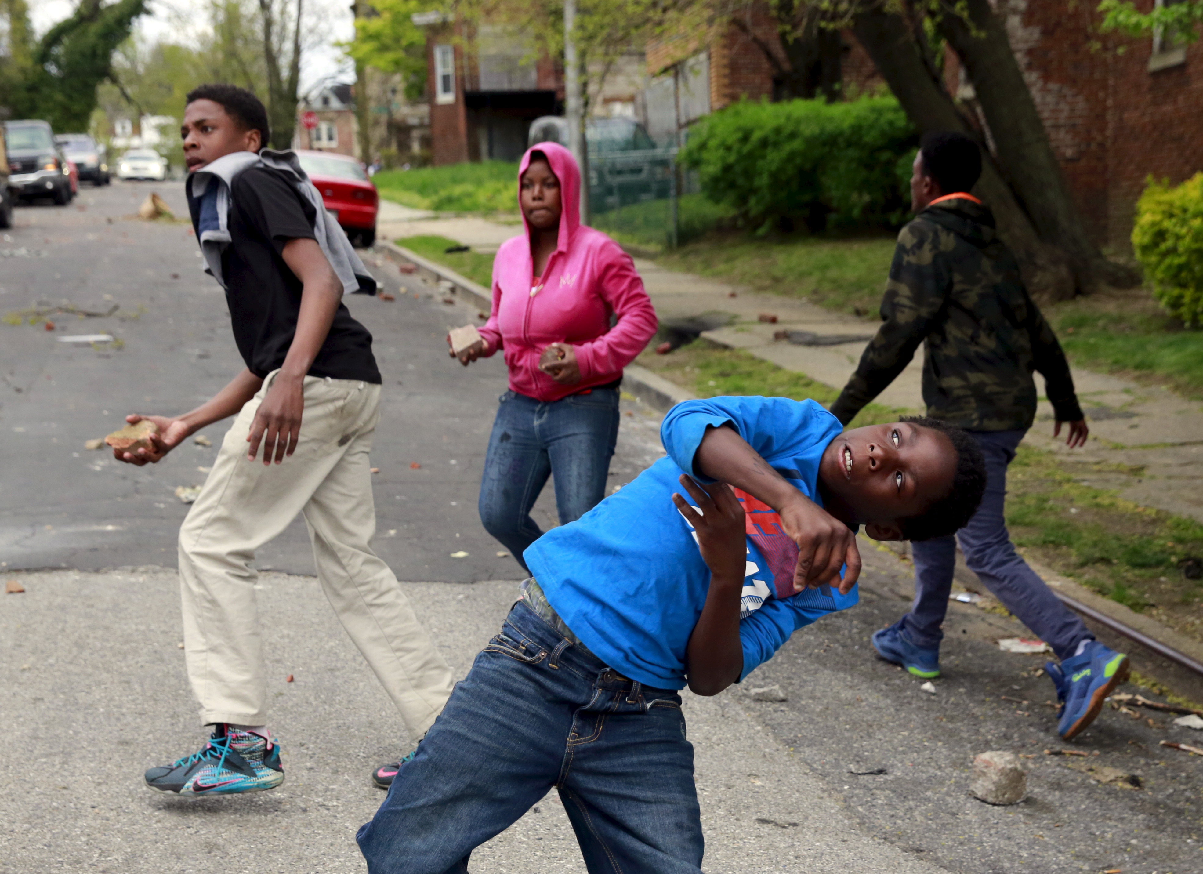 Demonstrators throw rocks at Baltimore police during clashes in Baltimore