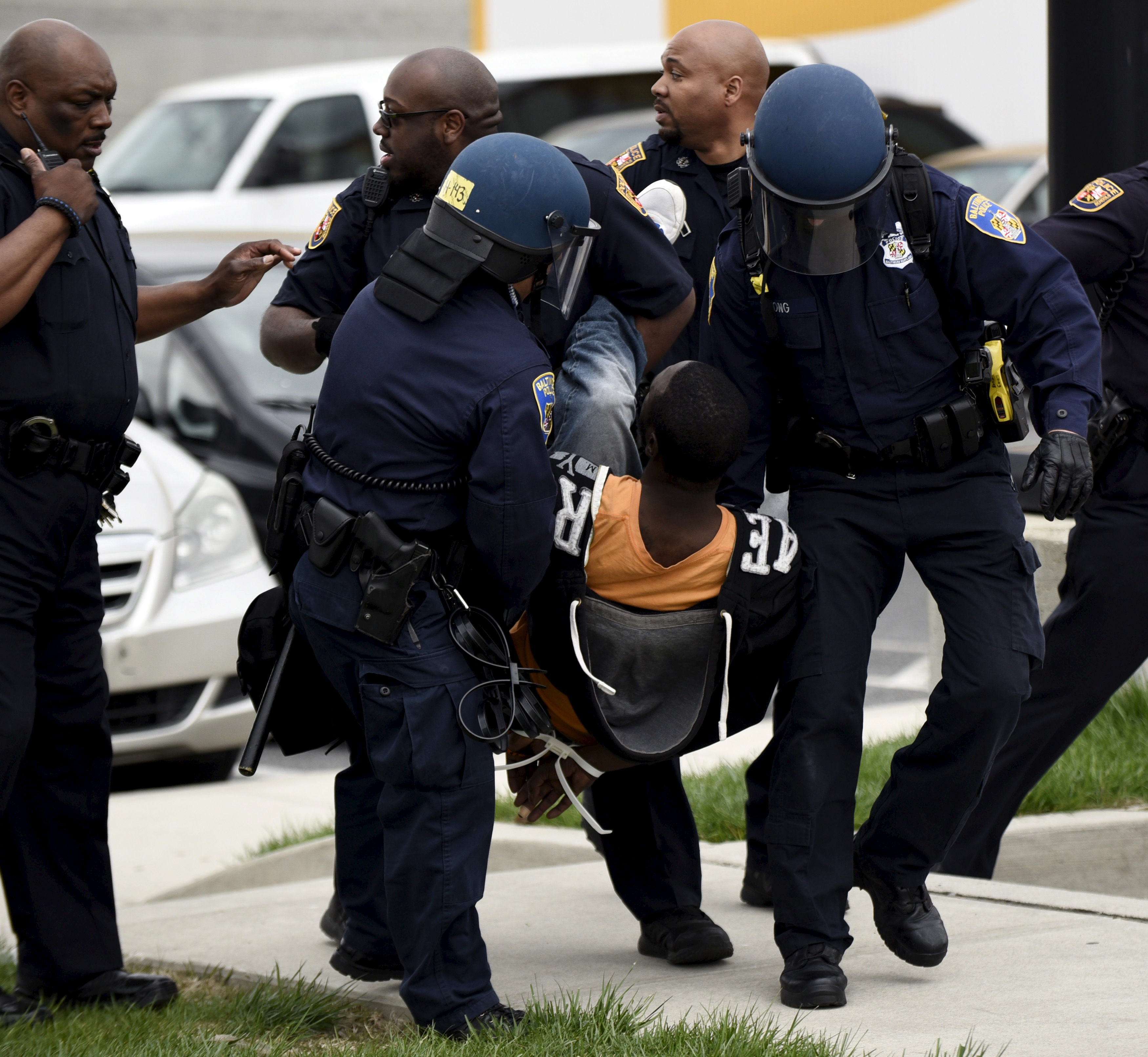 Policemen detain a protester near Mondawmin Mall after Freddie Gray's funeral in Baltimore