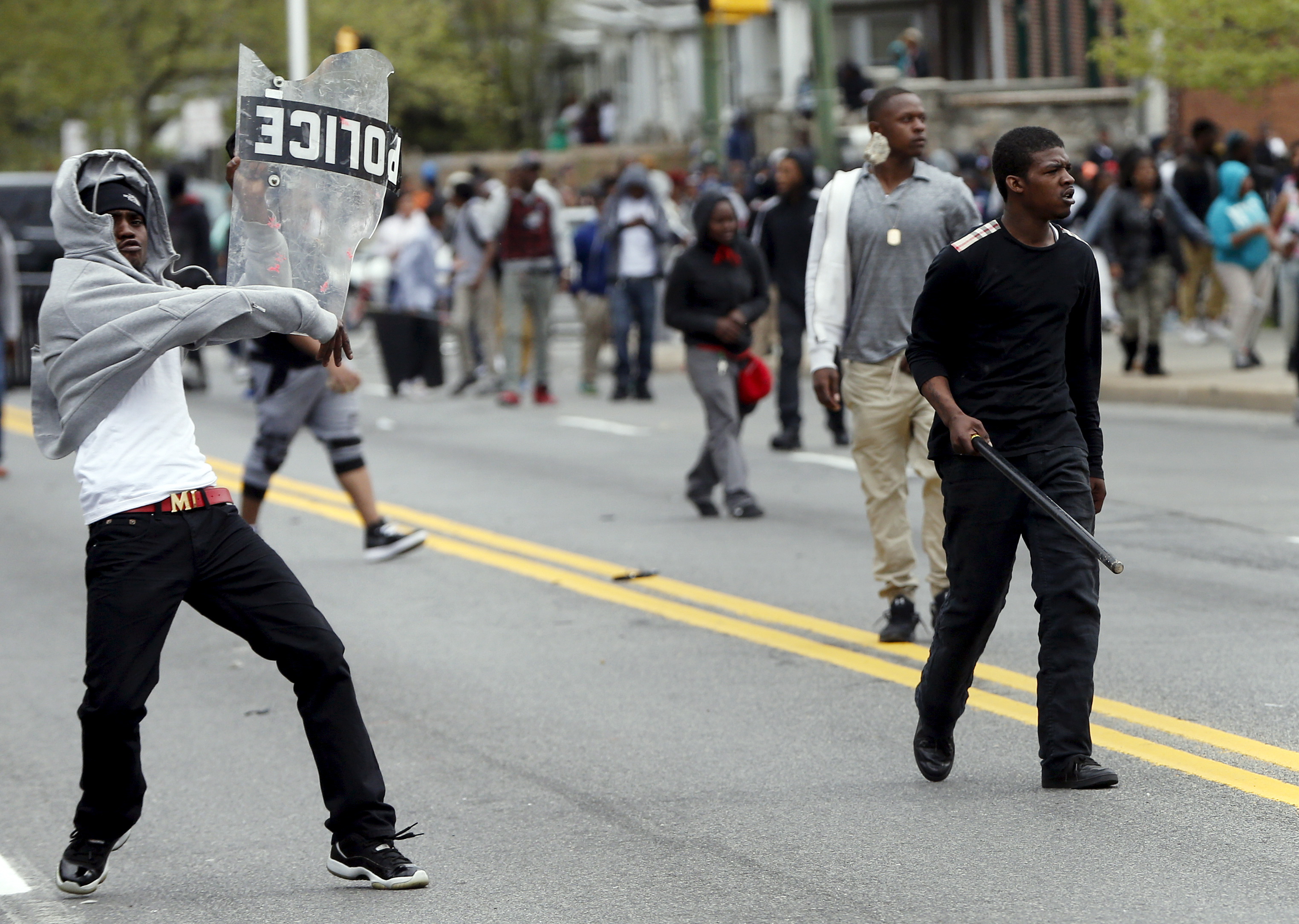 Demonstrators throw rocks at Baltimore police during clashes in Baltimore