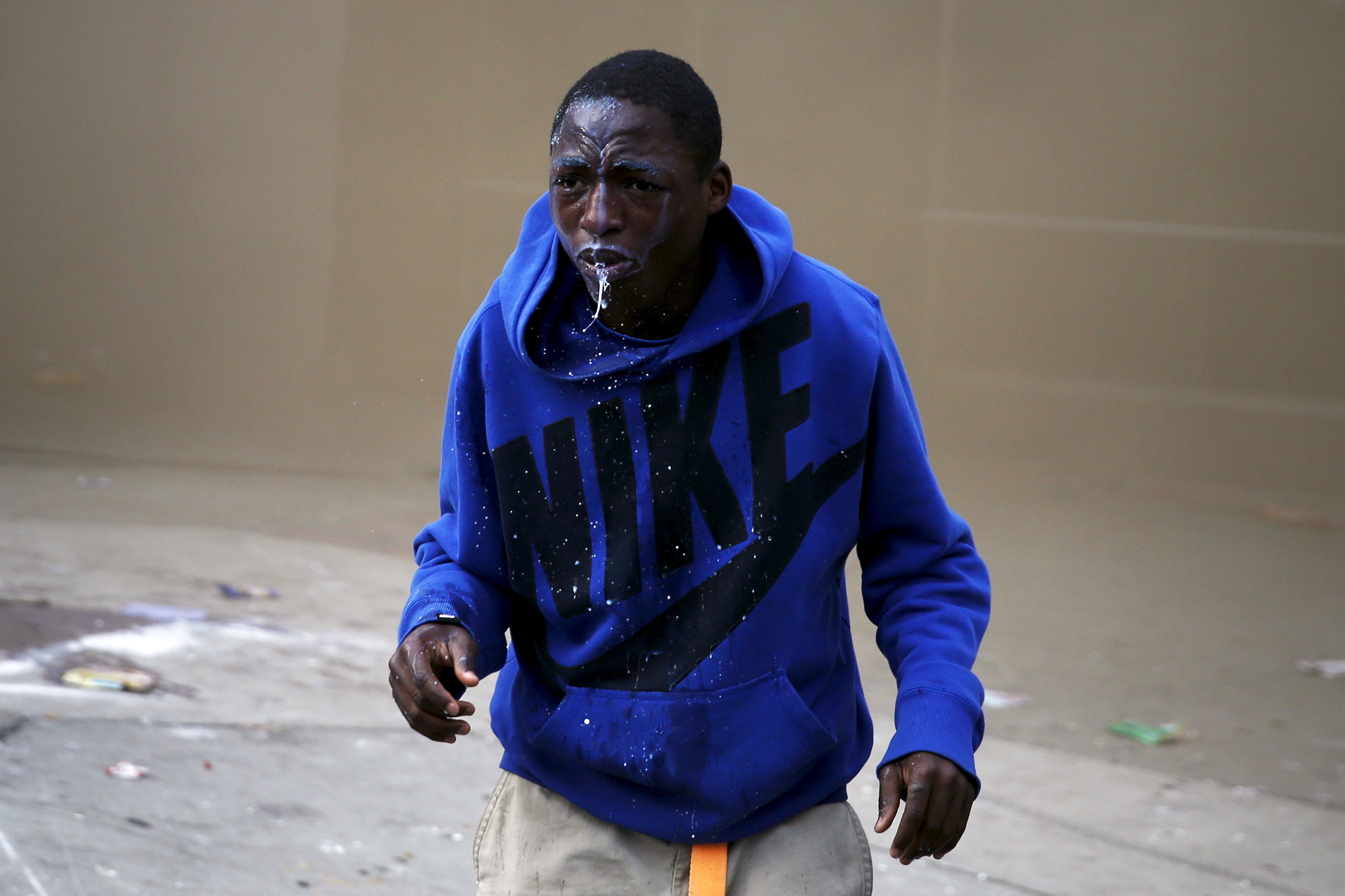 A demonstrator looks up after being sprayed with pepper spray during clashes in Baltimore, Maryland