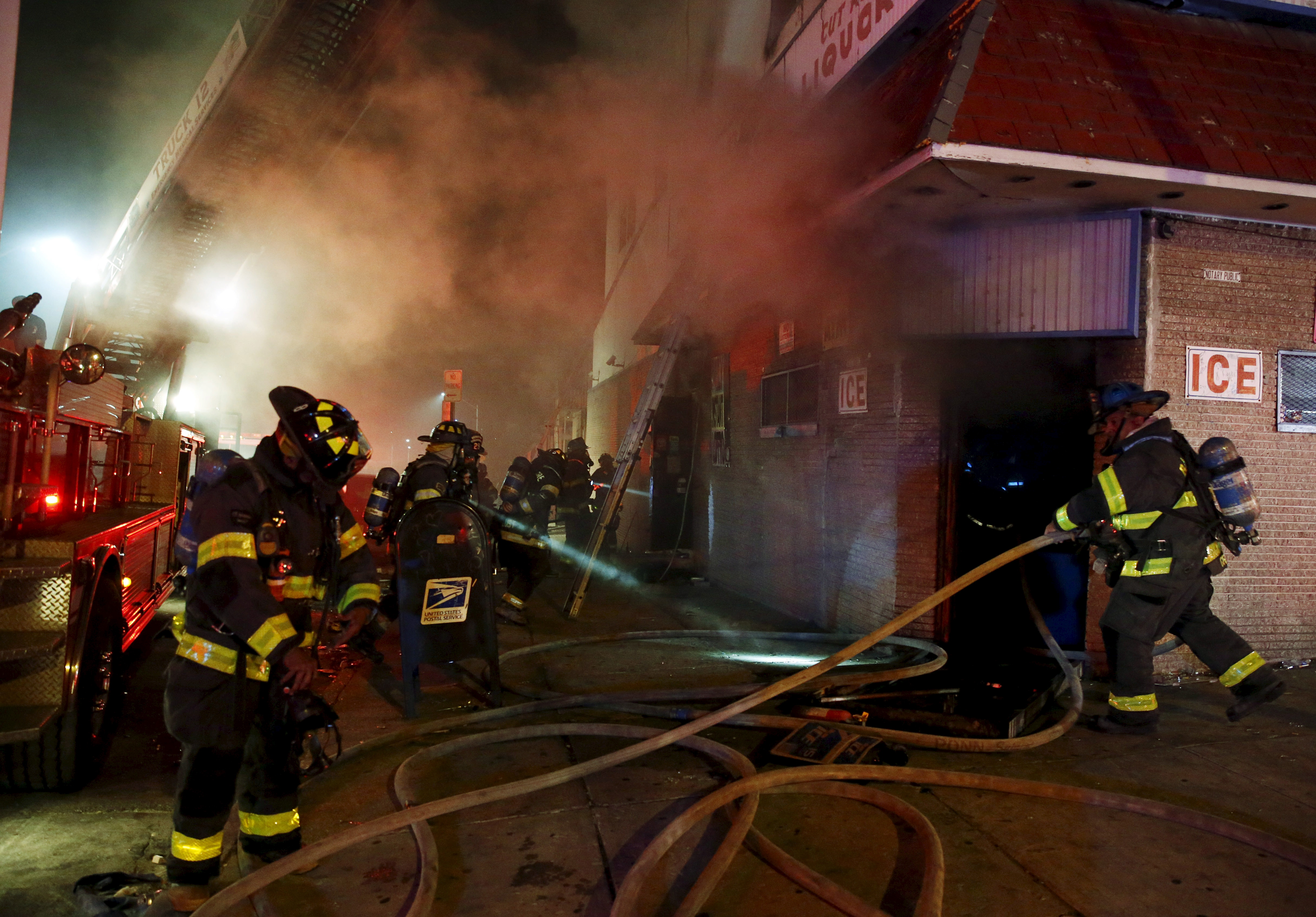 Baltimore firefighters fight fires in mutliple burning buildings set ablaze by rioters during clashes in Baltimore