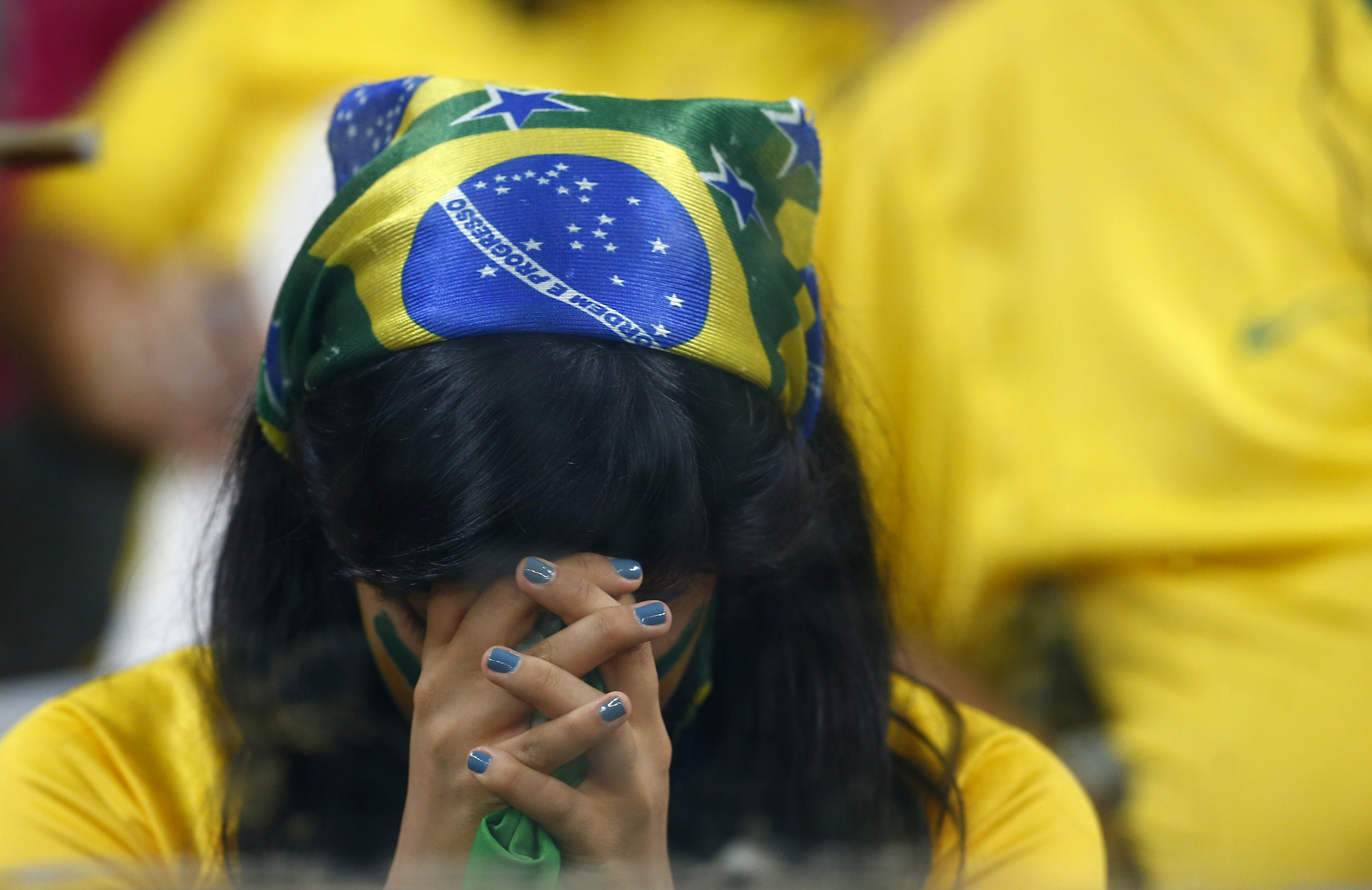 A Brazil fan reacts during the 2014 World Cup semi-finals between Brazil and Germany at the Mineirao stadium