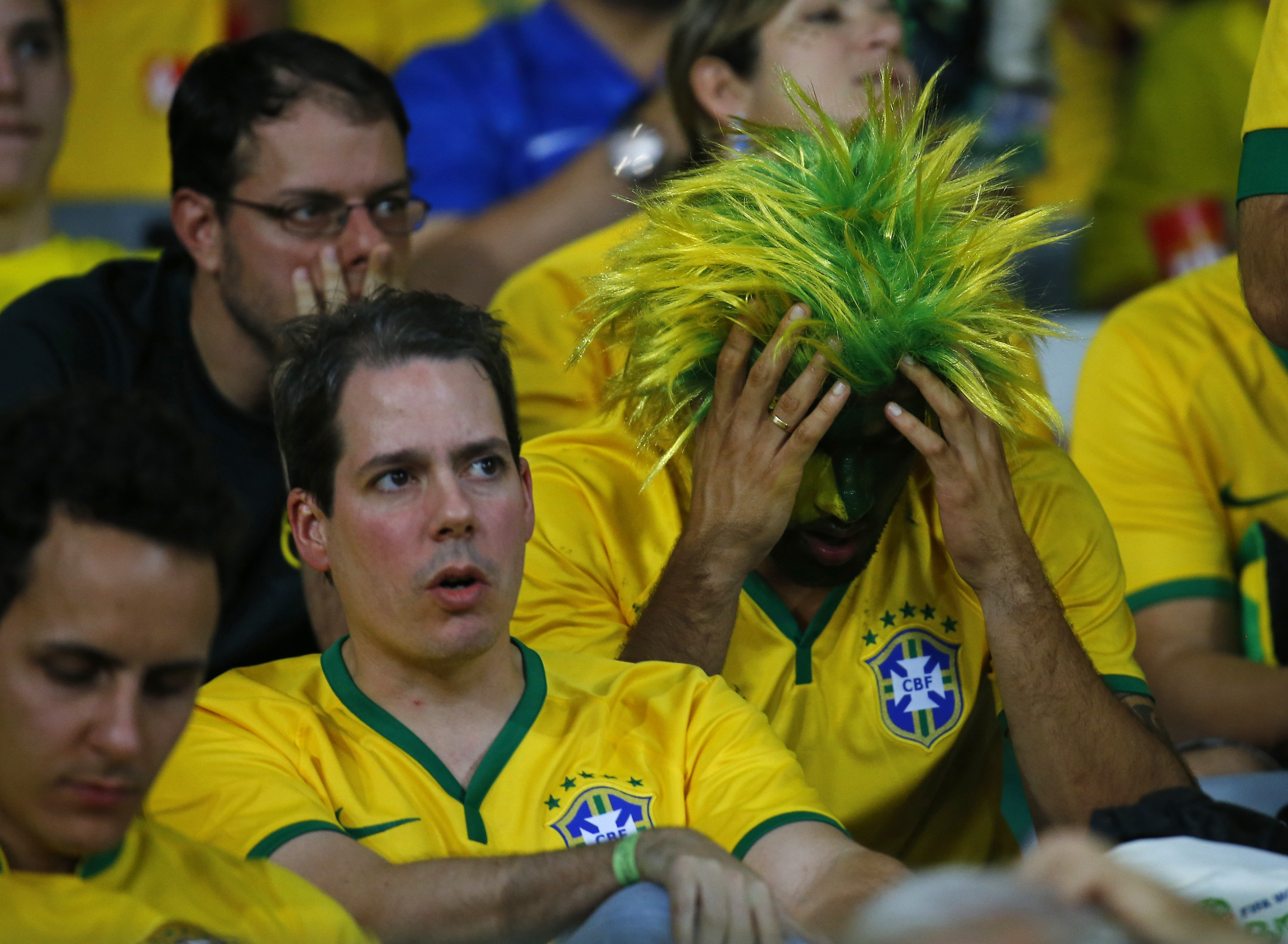 Brazil fans react at half-time during the team's 2014 World Cup semi-finals against Germany at the Mineirao stadium in Belo Horizonte 