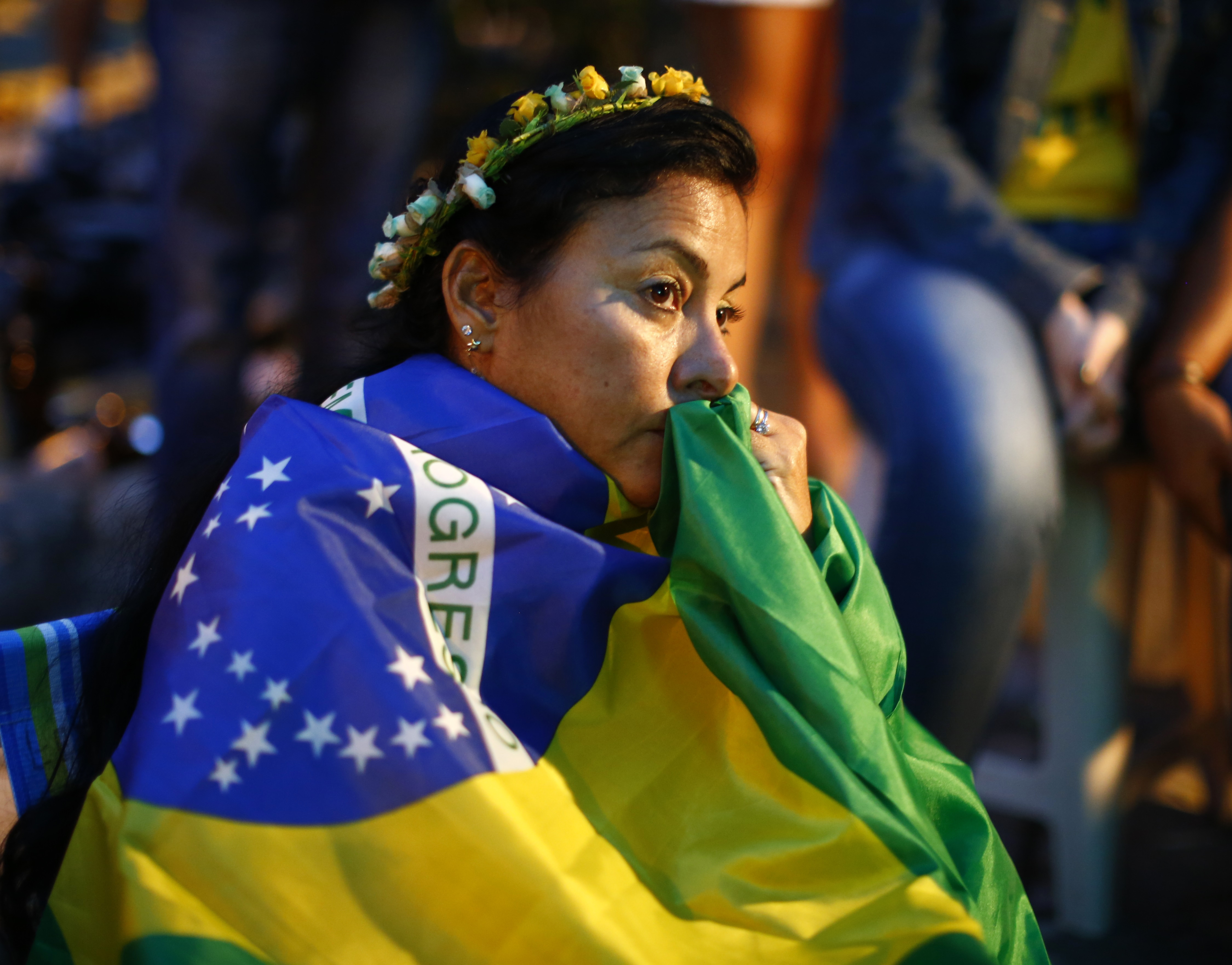 Brazil fans react as they watch their 2014 World Cup semi-finals against Germany on a street in Rio de Janeiro