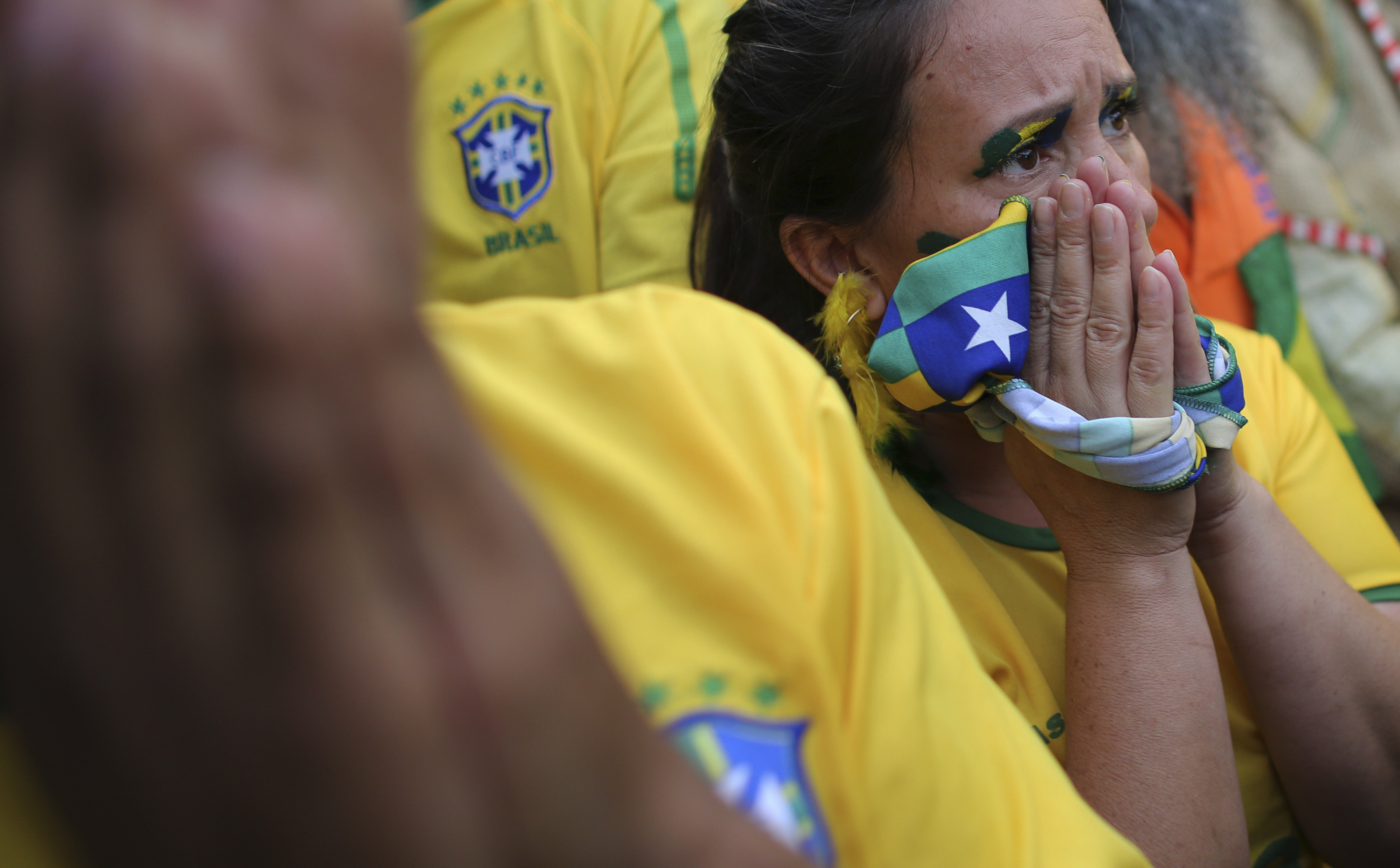 A Brazilian soccer fan reacts as she watches the 2014 World Cup semi- final soccer match between Brazil and Germany in Sao Paulo