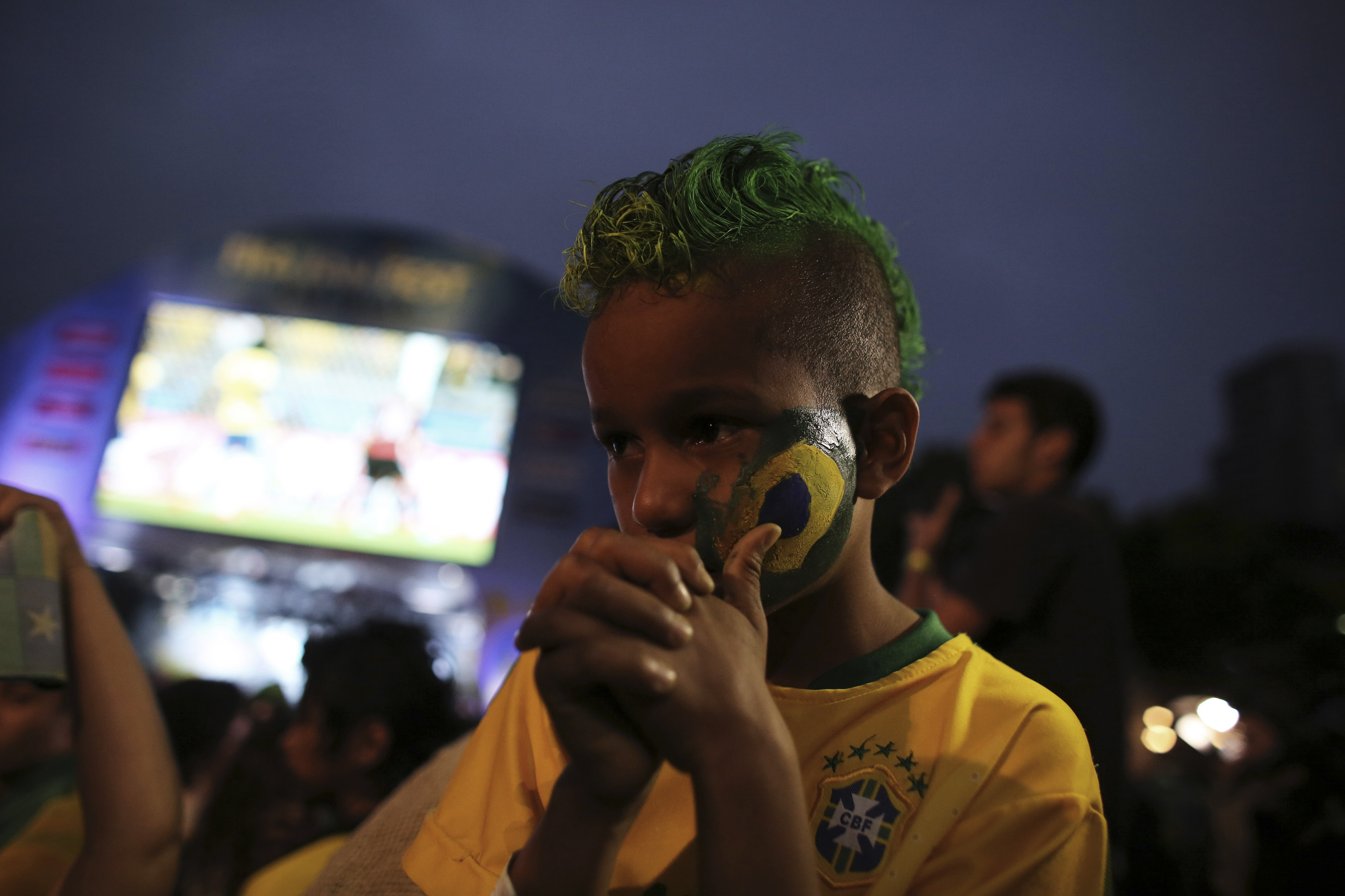 A Brazilian soccer fan cries as he watches the 2014 World Cup semi- final soccer match between Brazil and Germany in Sao Paulo 