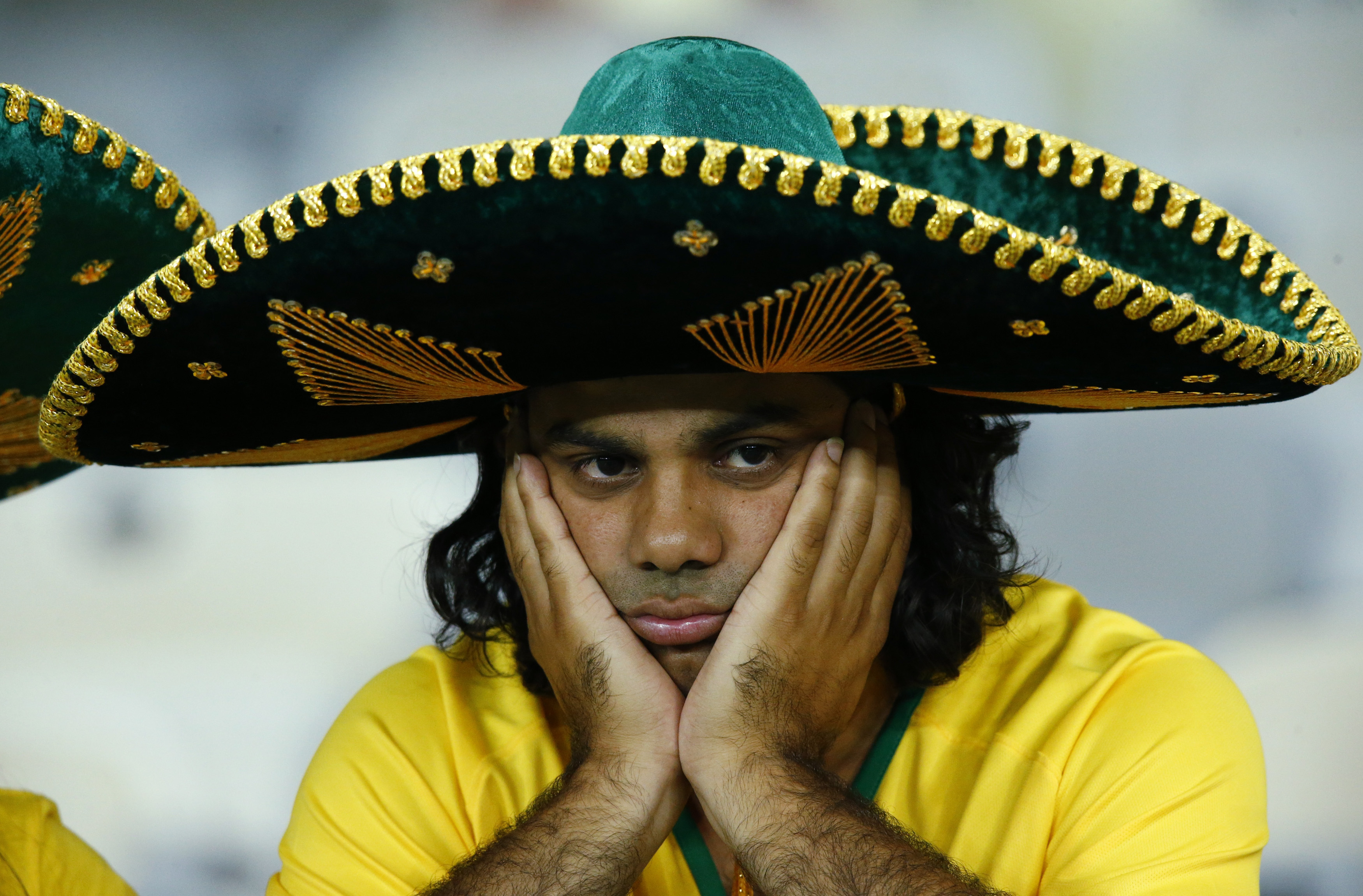 A Brazil fan reacts after the team's 2014 World Cup semi-finals against Germany at the Mineirao stadium in Belo Horizonte