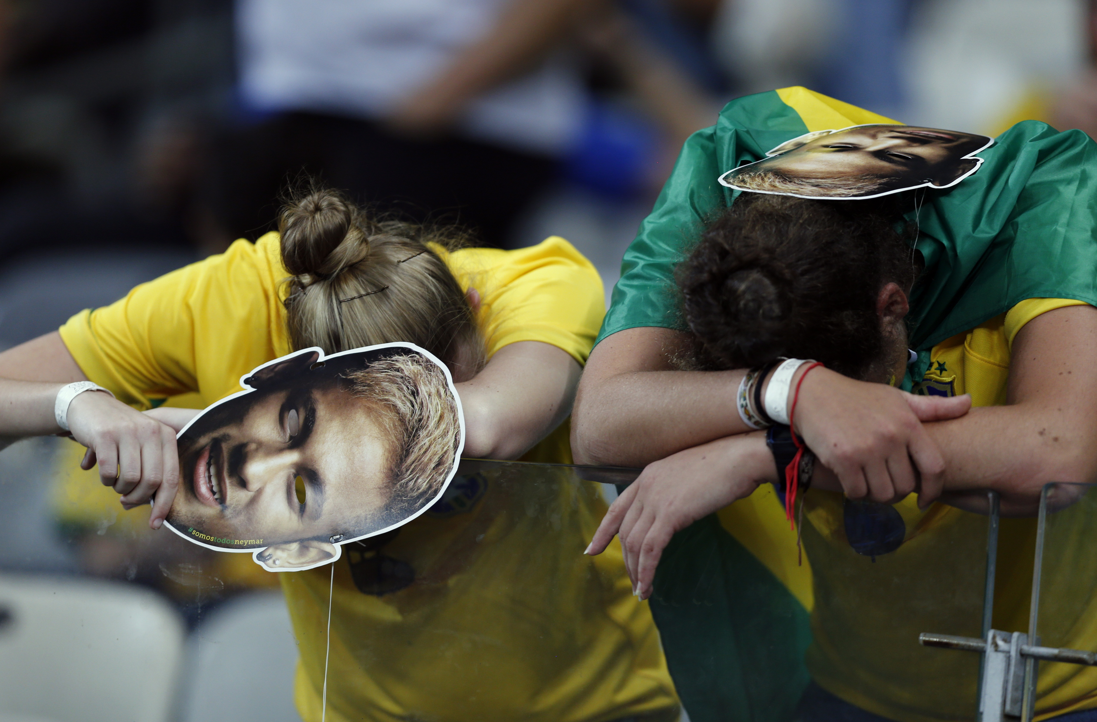 Fans of Brazil react after their loss to Germany in their 2014 World Cup semi-finals at the Mineirao stadium in Belo Horizonte