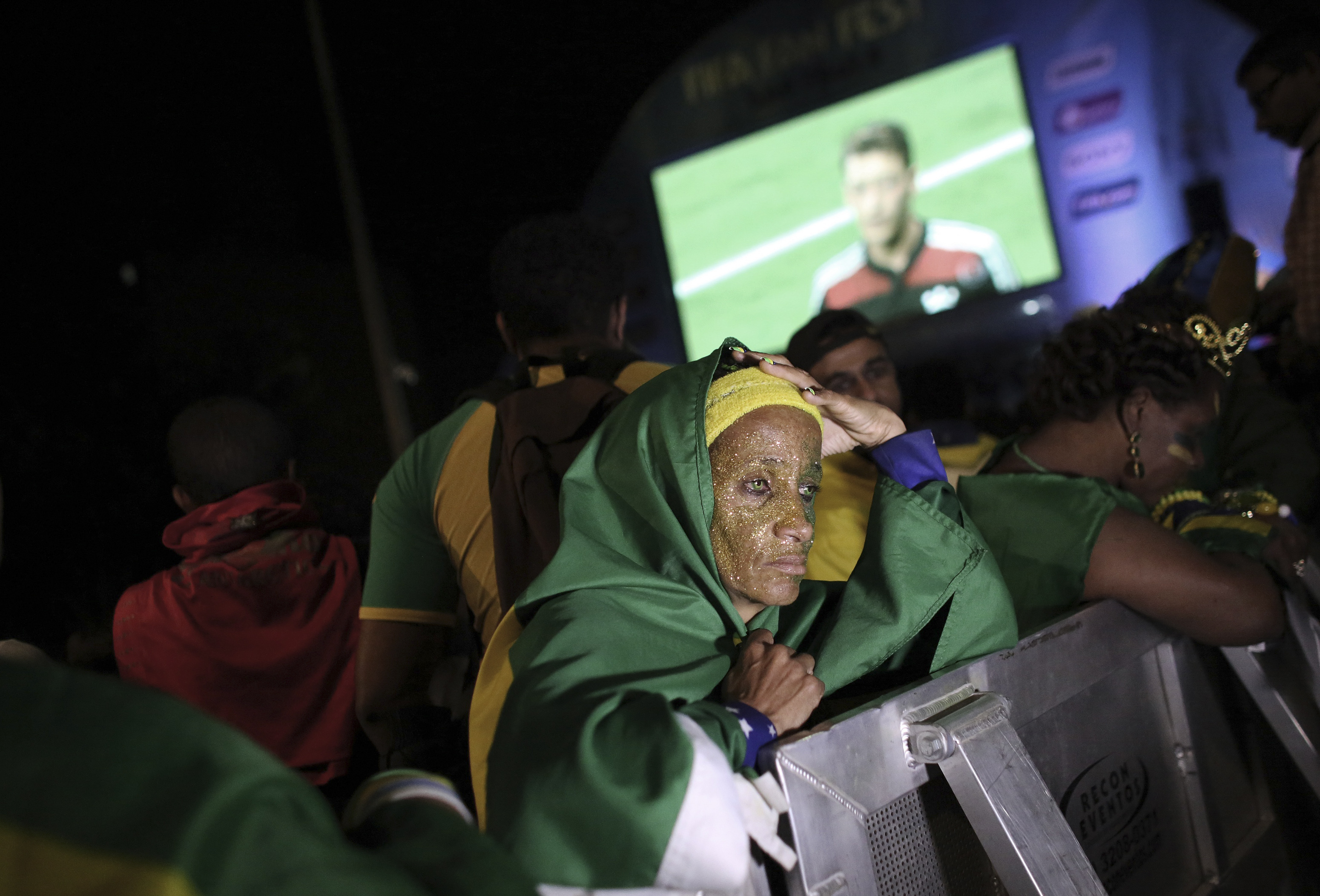 A Brazilian fan reacts while watching a broadcast of the 2014 World Cup semi- final soccer match between Brazil and Germany in Sao Paulo