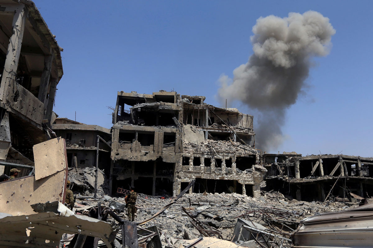 Smoke rises from an air strike during clashes with Islamic State militants in the Old City of Mosul