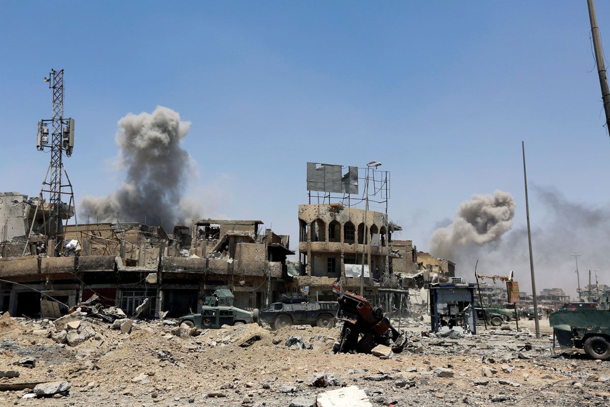 Smoke rises from an air strike during fighting with Islamic State militants in the Old City of Mosul