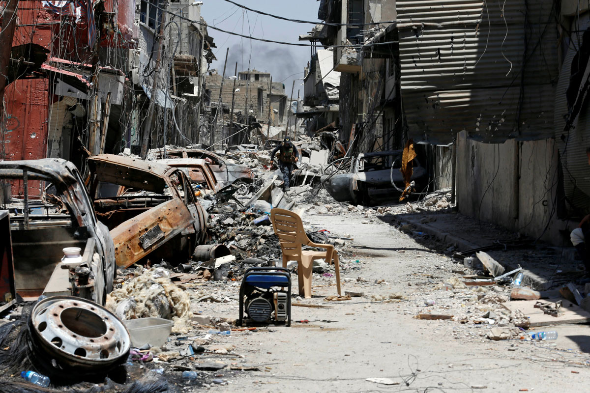 A member of the Iraqi Federal Police runs for cover on the frontline in the Old City of Mosul