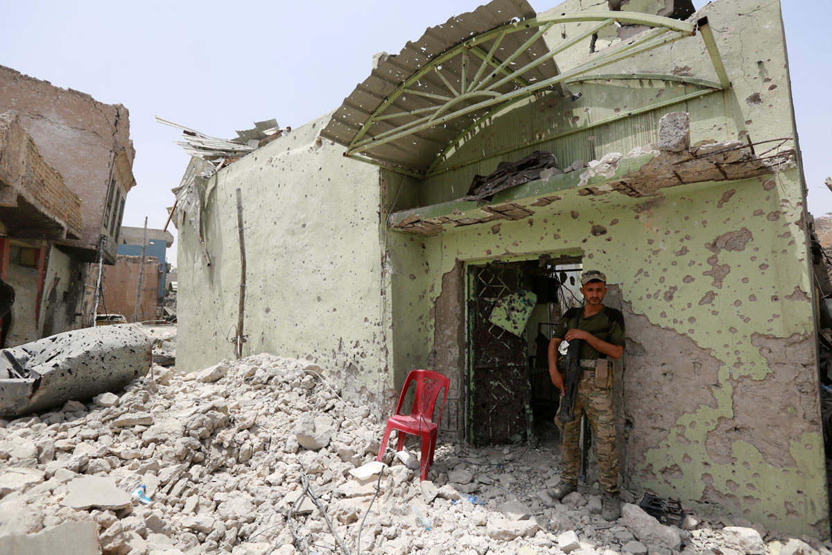 A member of the Iraqi security forces carries his weapon during fighting between Iraqi forces and Islamic State militants in the Old City of Mosul