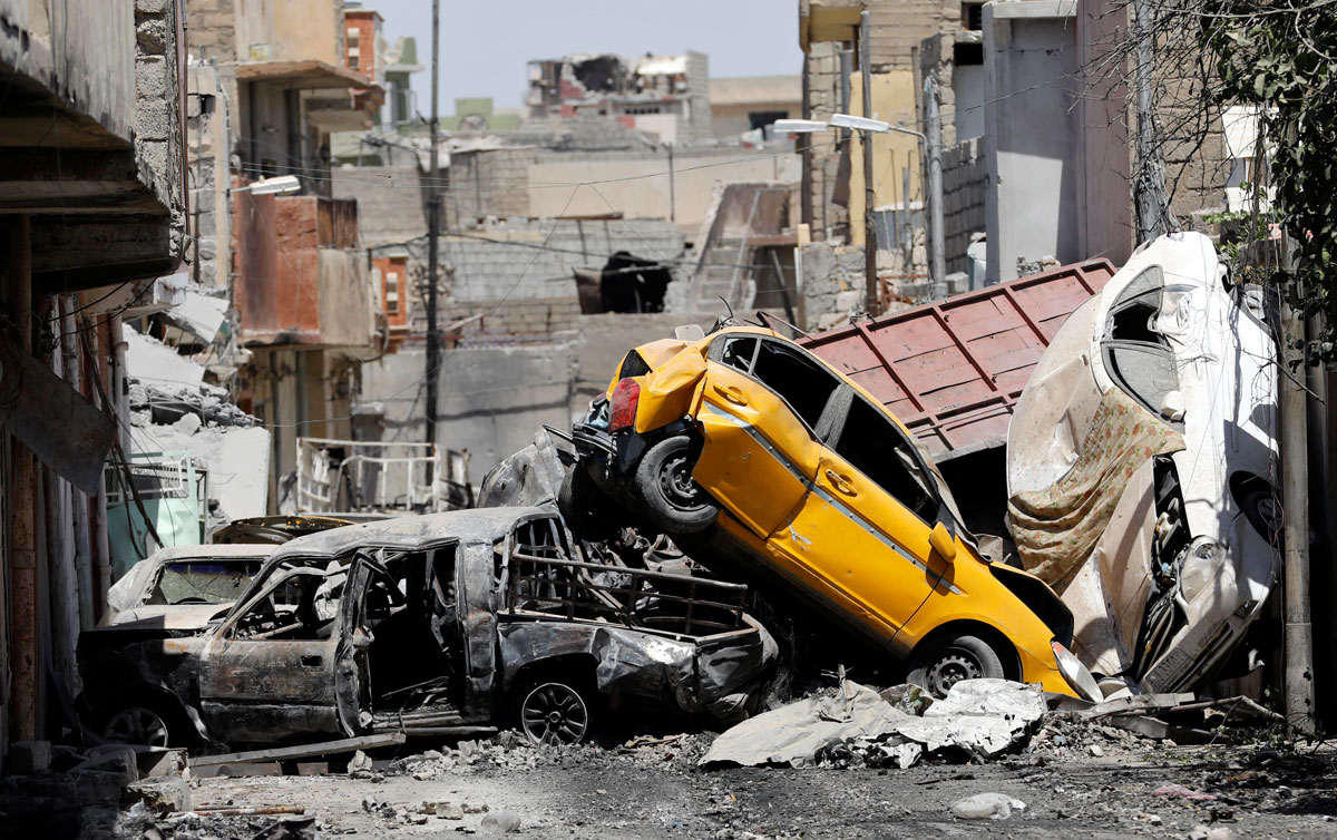 Vehicles piled on top of each other are seen at the site of fighting between the Iraqi forces and Islamic State militants in Mosul's al-Zanjili's district