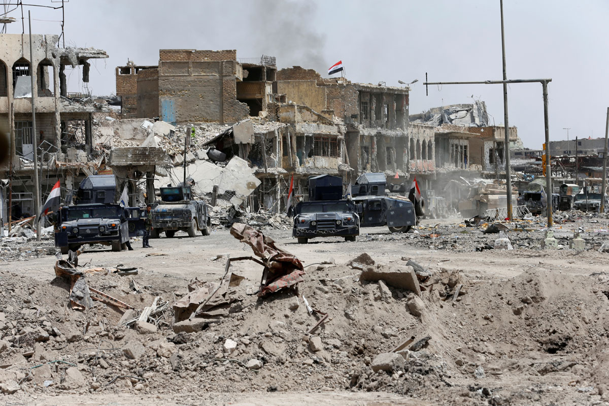 Vehicles of the Fedral police are seen during the fight with the Islamic States militants in the Old City of Mosul