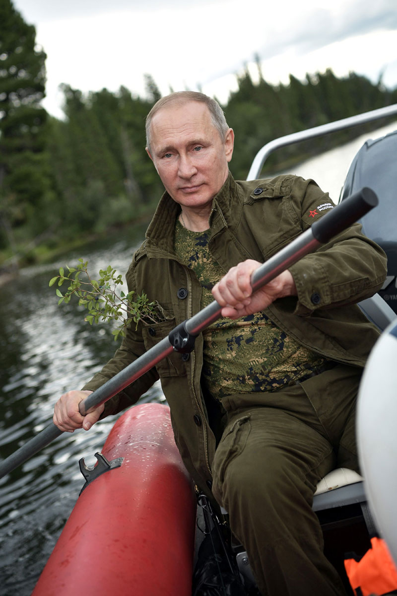 Russian President Vladimir Putin rows a boat during the hunting and fishing trip which took place on August 1-3 in the republic of Tyva in southern Siberia