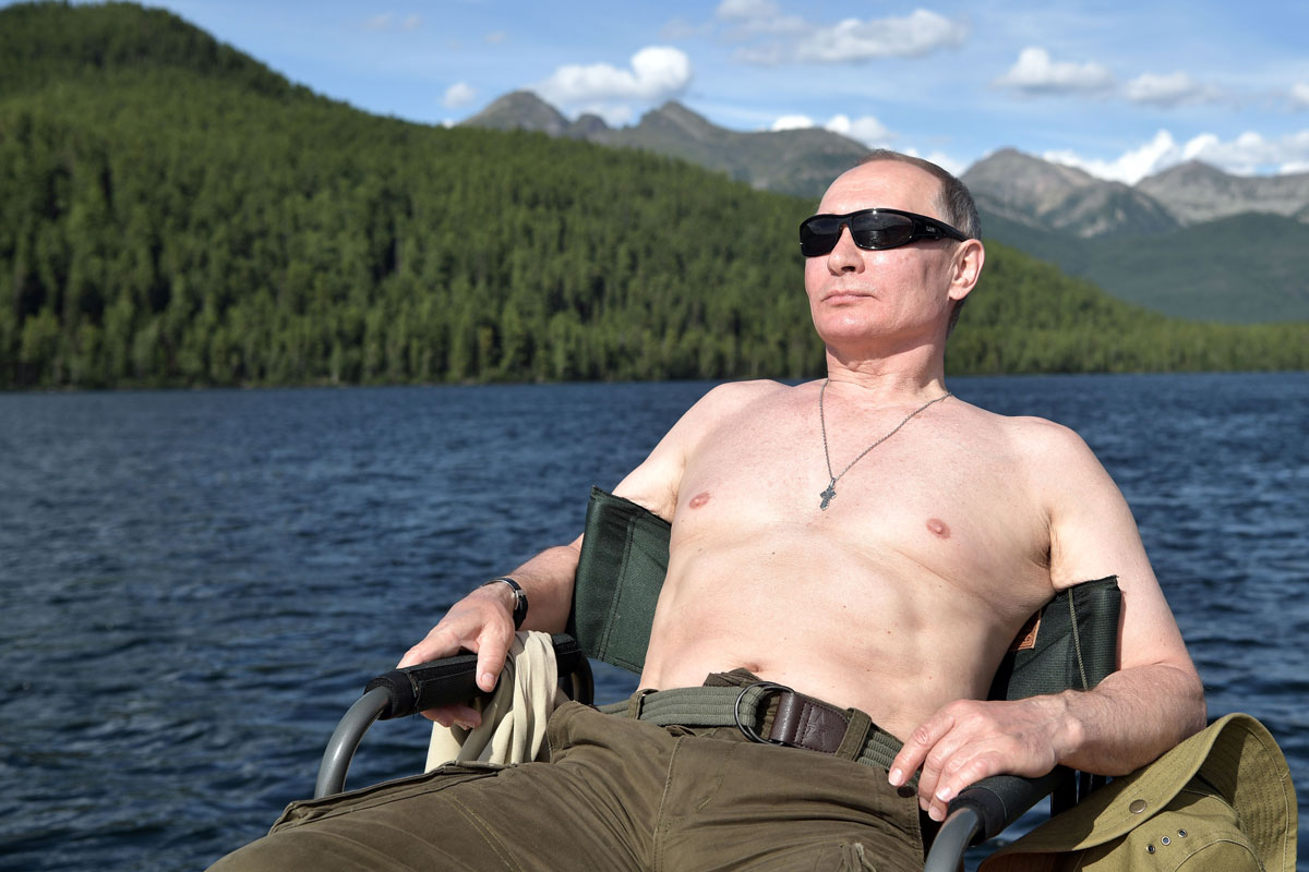 Russian President Vladimir Putin relaxes after fishing during the hunting and fishing trip which took place on August 1-3 in the republic of Tyva in southern Siberia