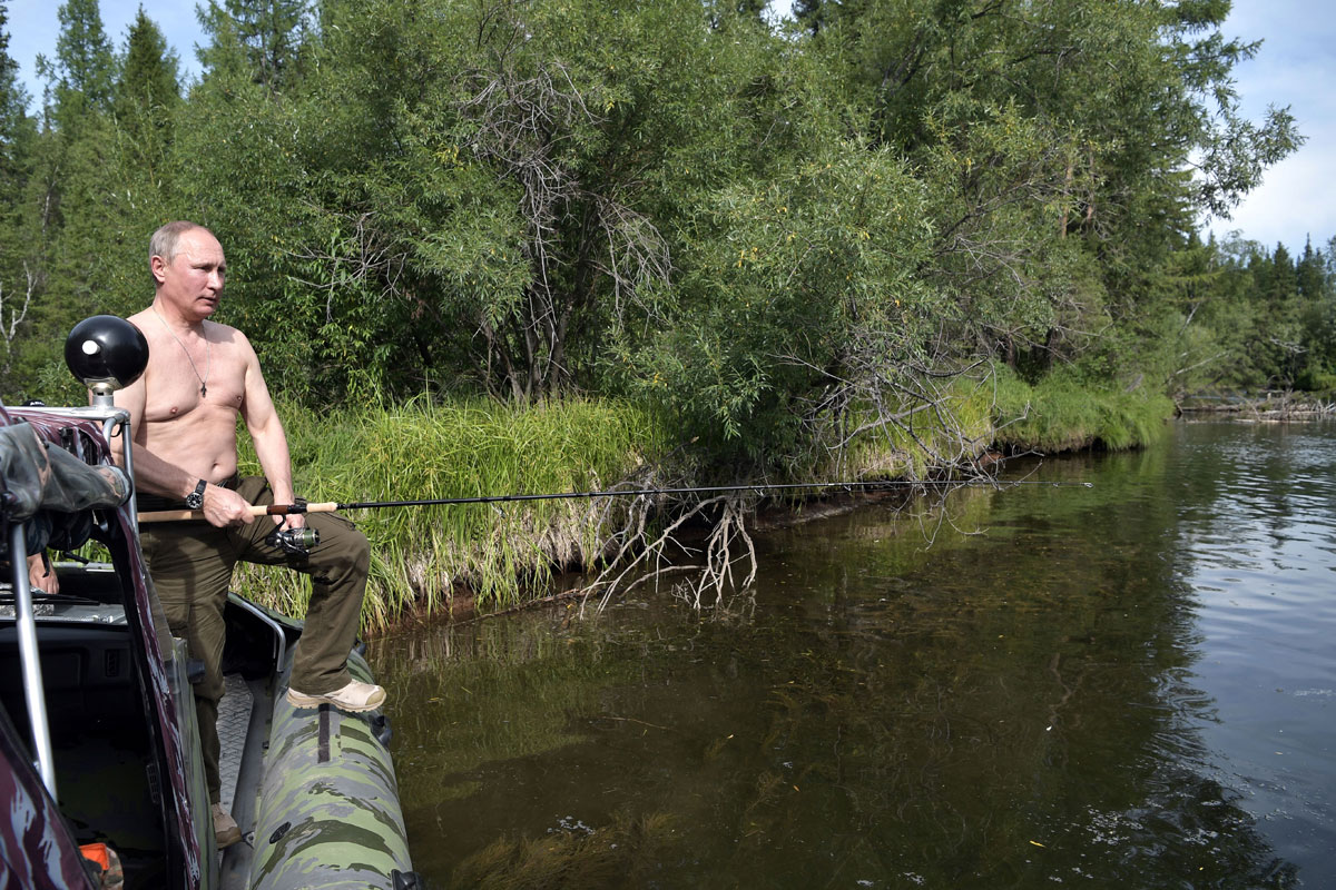 Russian President Vladimir Putin fishes during the hunting and fishing trip which took place on August 1-3 in the republic of Tyva in southern Siberia