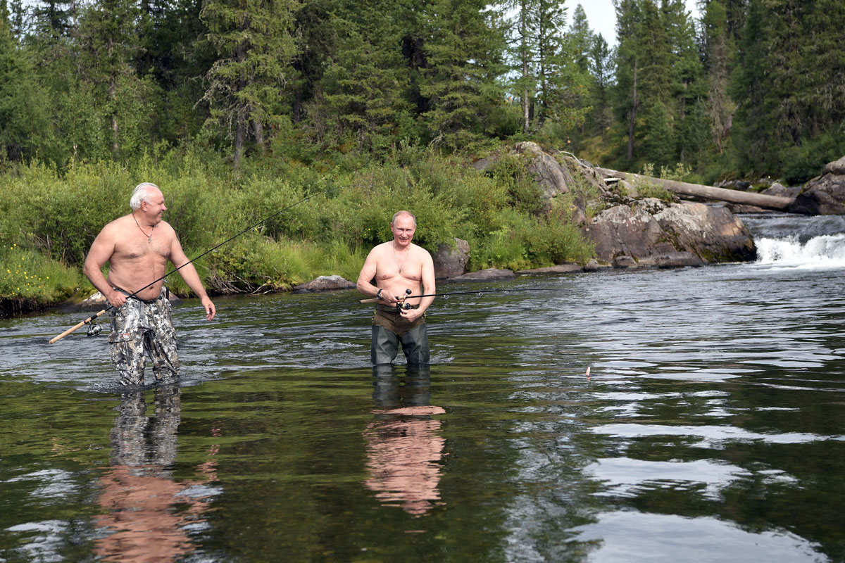 Russian President Vladimir Putin and head of the Republic of Khakassia Viktor Zimin fish during the hunting and fishing trip which took place on August 1-3 in the republic of Tyva in southern Siberia