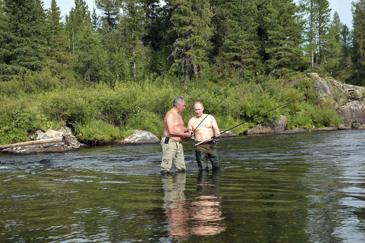 Russian President Vladimir Putin and Defence Minister Sergei Shoigu fish during the hunting and fishing trip which took place on August 1-3 in the republic of Tyva in southern Siberia