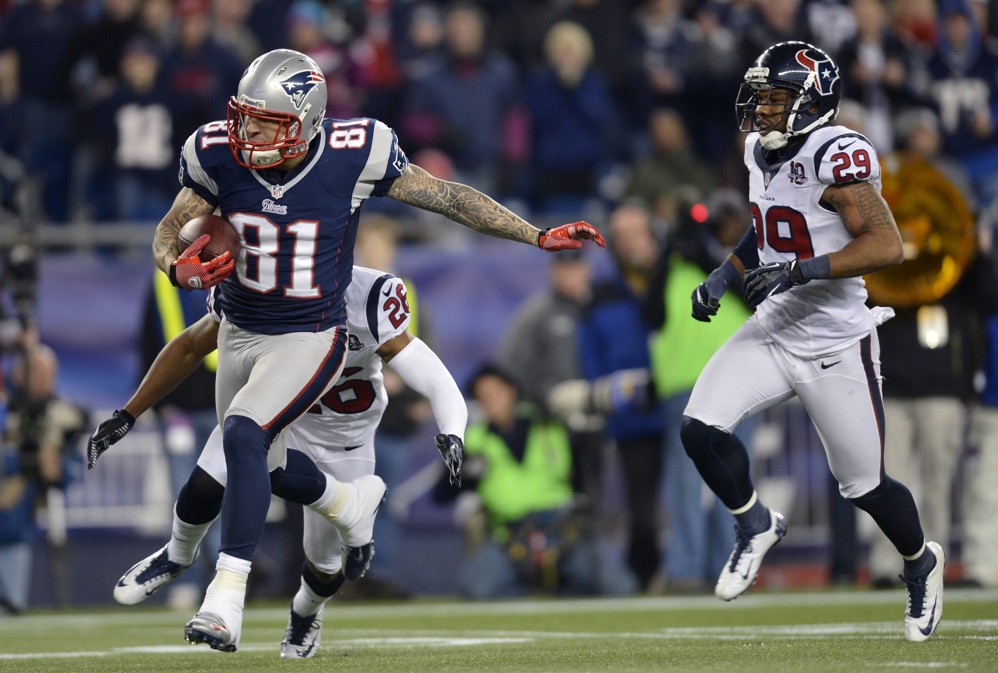 New England Patriots' Aaron Hernandez runs for a long gain after a catch in third quarter of their NFL AFC Divisional playoff football game against the Houston Texans in Foxborough