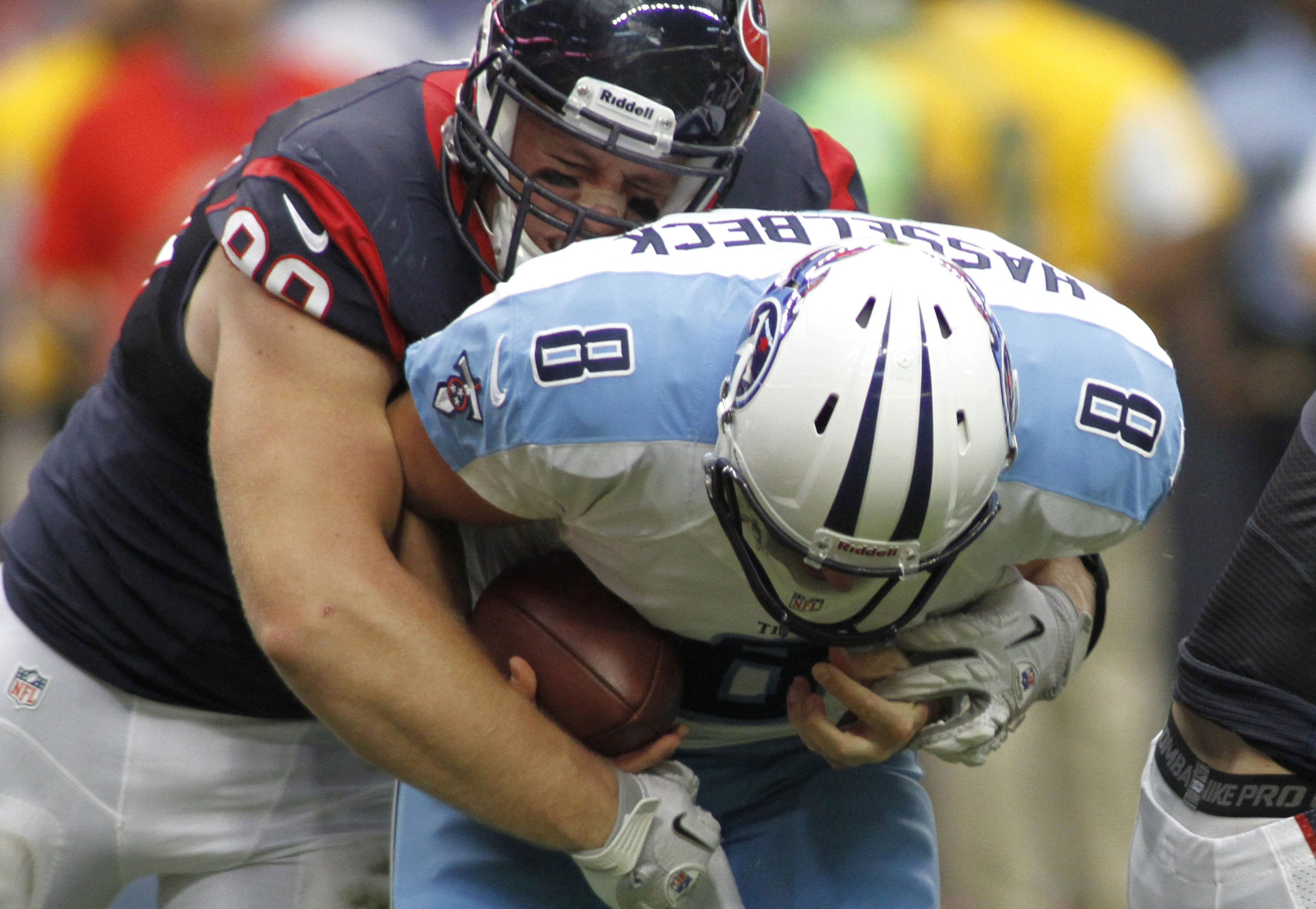 Houston Texans defensive end J.J. Watt grimaces as he sacks Tennessee Titans quarterback Matt Hasselbeck in Houston