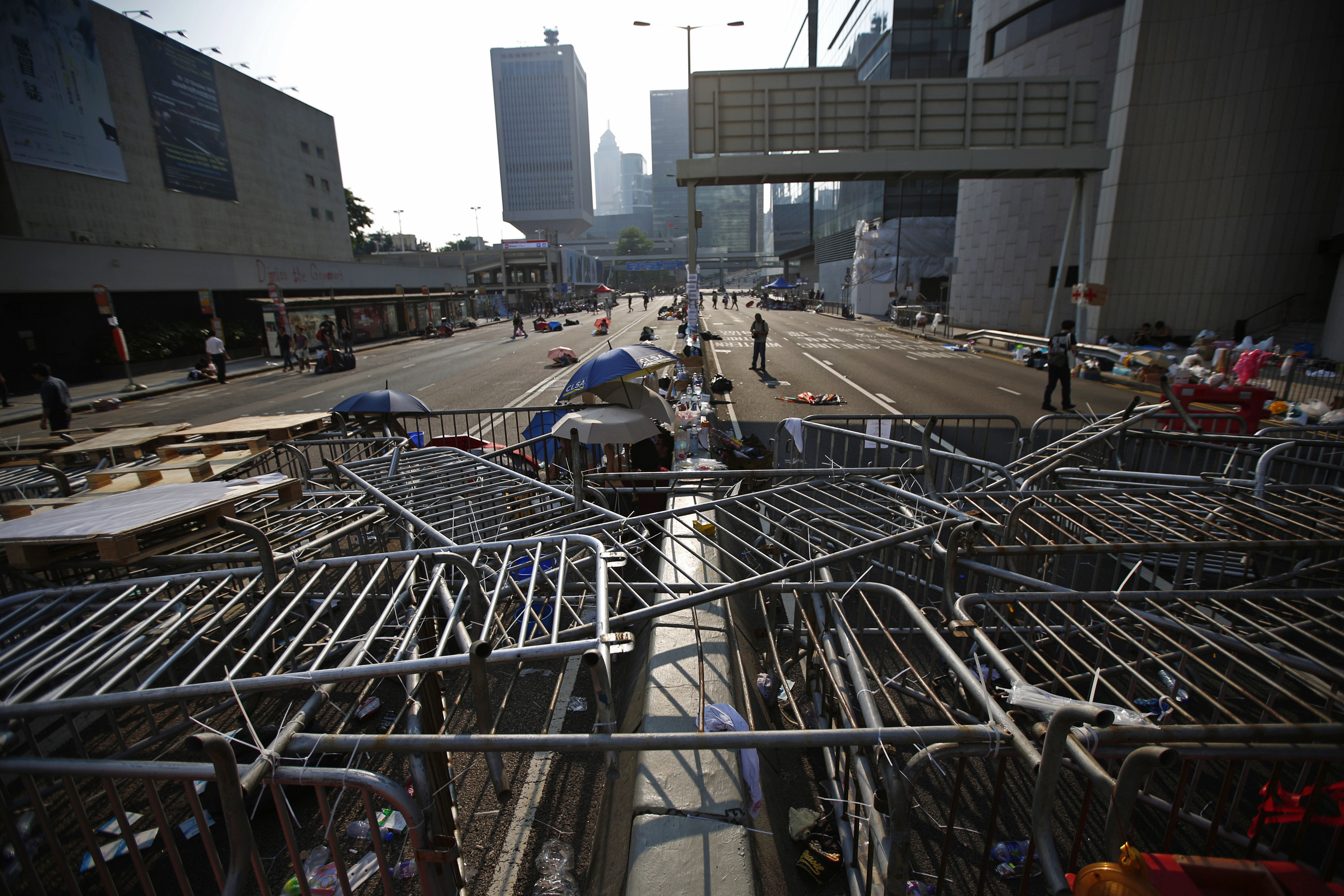 A barricade of metal fences is seen as protesters block a street, near the government headquarters in Hong Kong