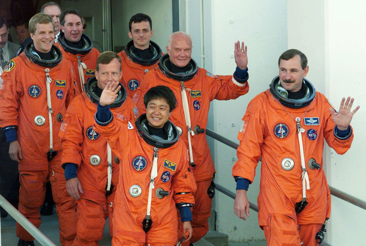 The crew of the space shuttle Discovery walks from their crew quarters as they depart for the launch..