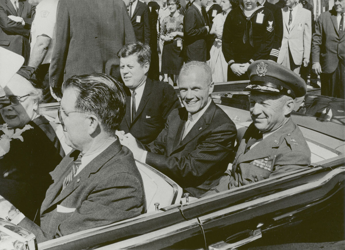 U.S. President John F. Kennedy, astronaut John Glenn and General Leighton I. Davis ride together during a parade in Cocoa Beach