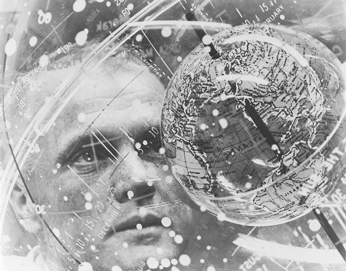 Astronaut John H. Glenn Jr. looks into a globe, technically the "Celestial Training Device" at the Aeromedical Laboratory at Cape Canaveral