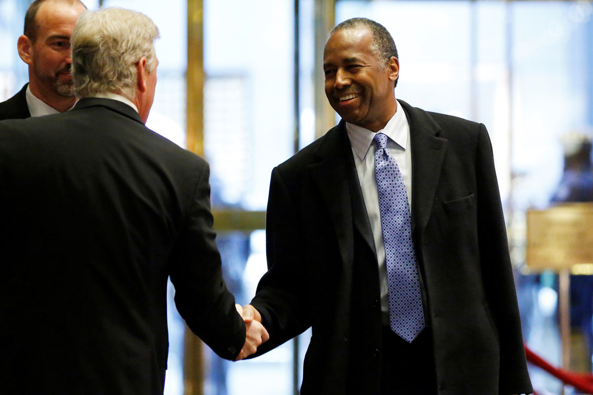 Ben Carson, President-elect Donald Trump's nominee to be secretary of housing and urban development, smiles as he enters the lobby of Trump Tower in Manhattan, New York