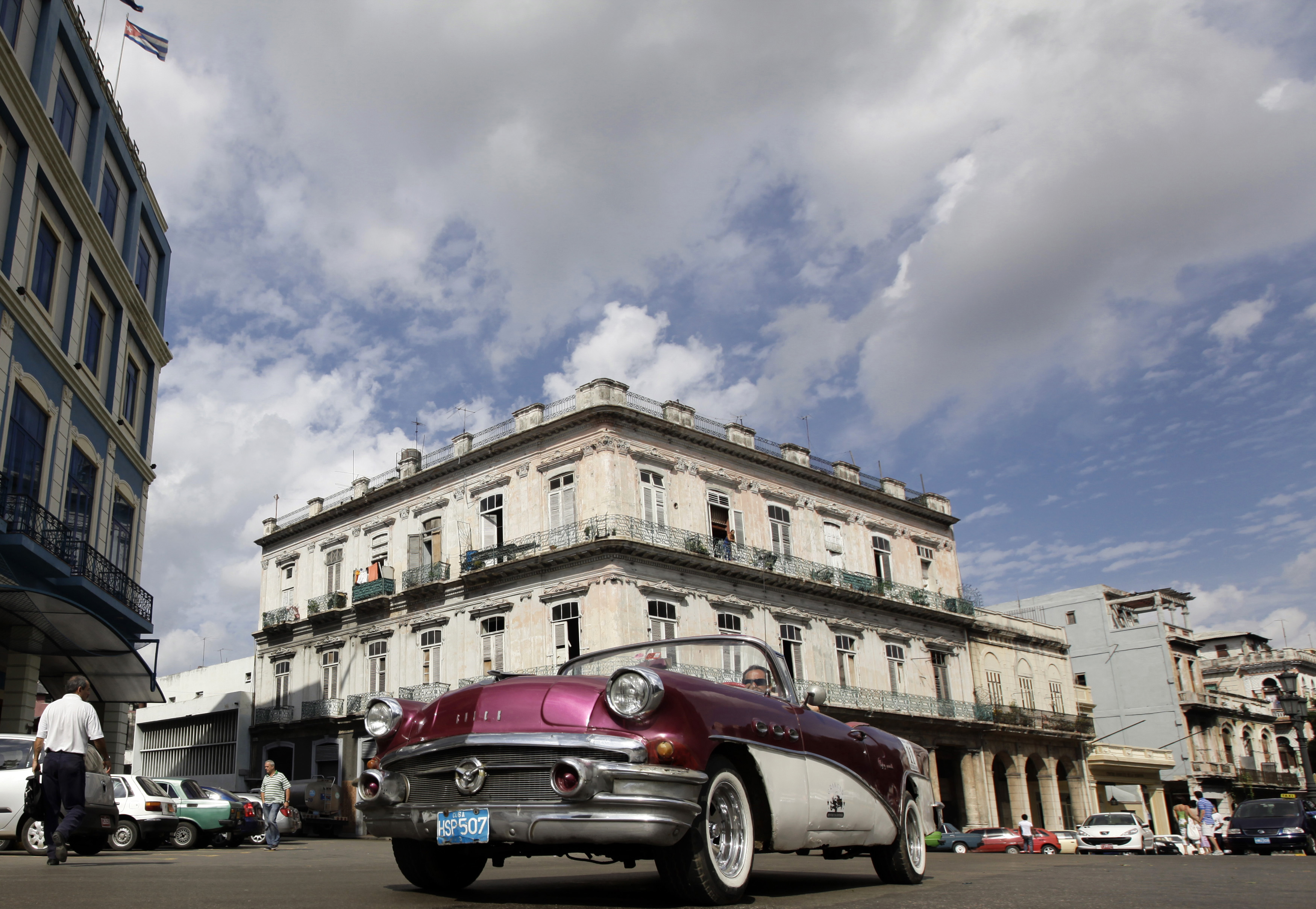 A Buick 1956 convertible is driven on a street in Havana