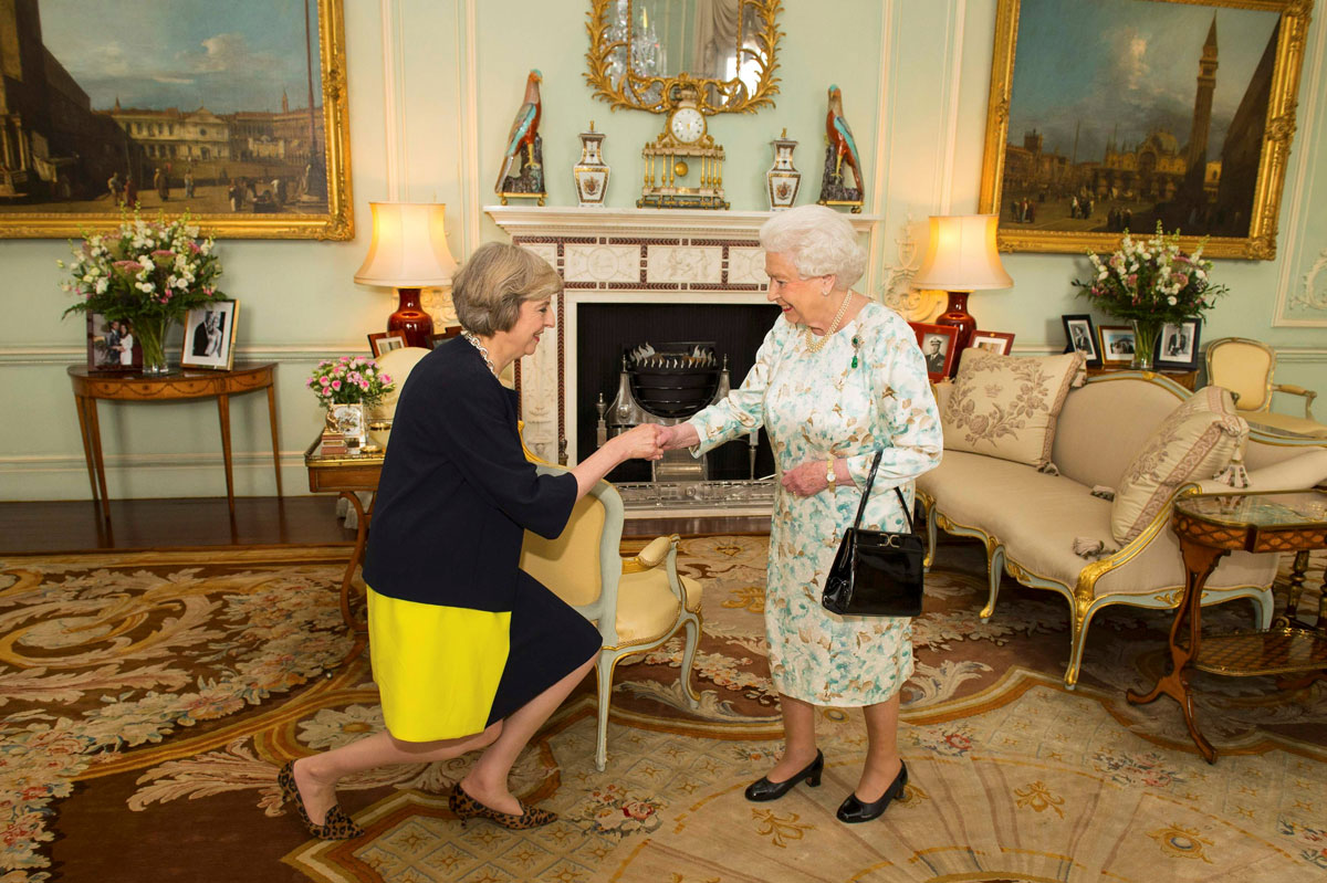 Britain's Queen Elizabeth welcomes Theresa May at the start of an audience in Buckingham Palace, where she invited her to become Prime Minister, in London