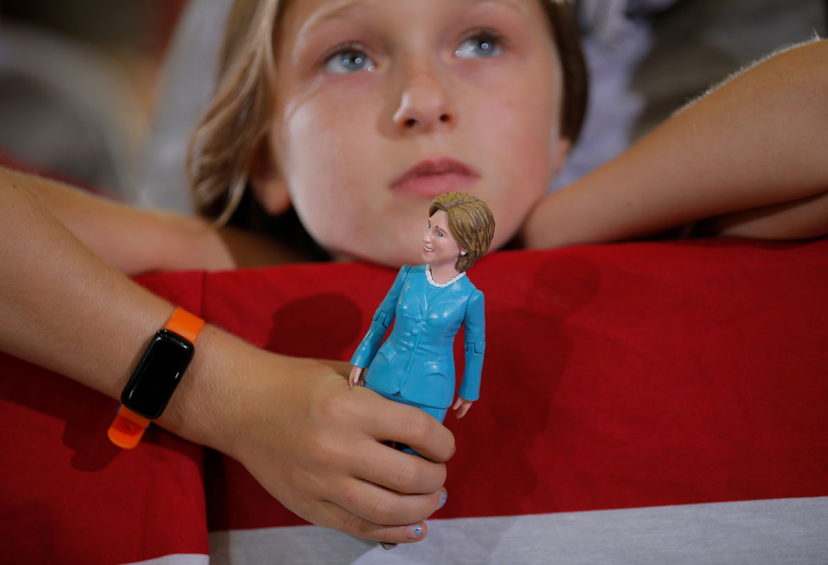 Nine-year-old Belle Shefrin holds a doll of U.S. Democratic presidential nominee Hillary Clinton while listening to Clinton speak at a campaign rally in Akron