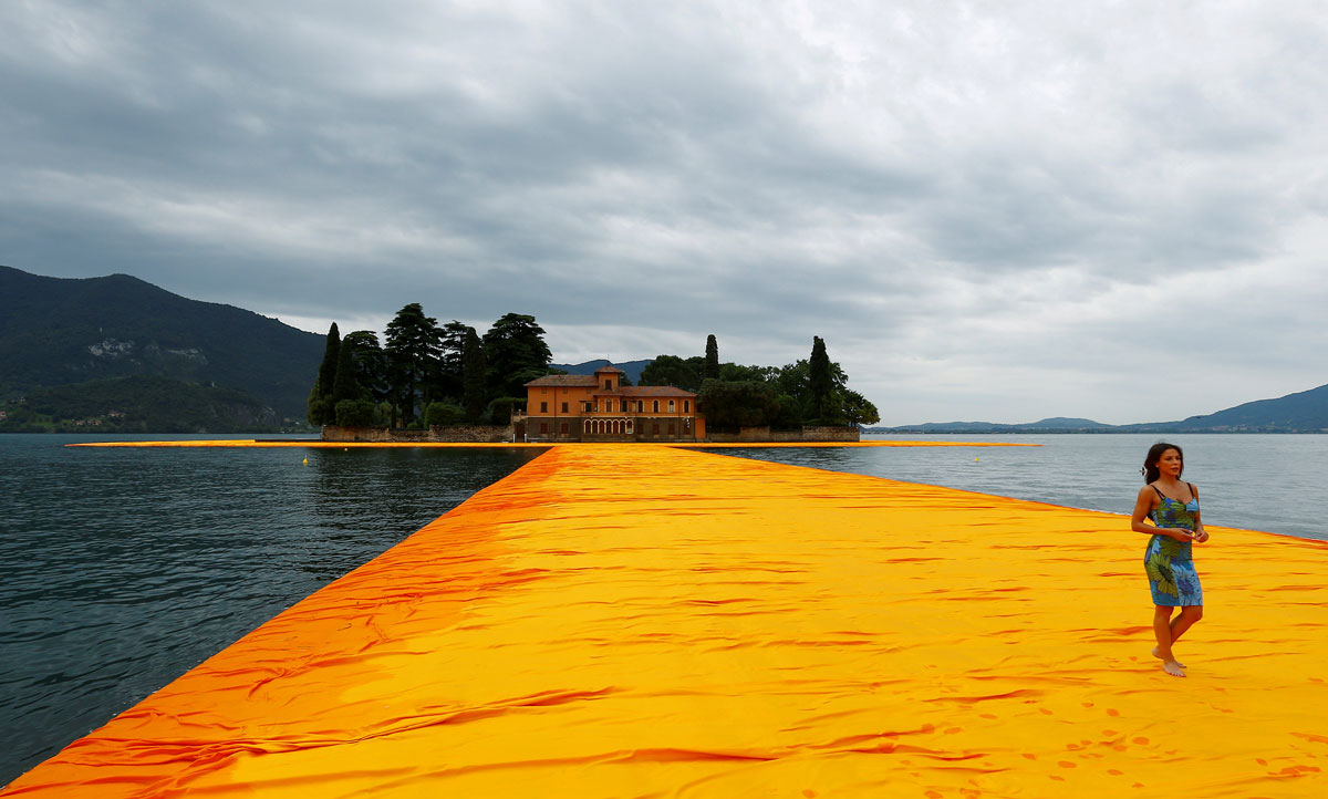 A woman walks on the installation 'The Floating Piers' on the Lake Iseo