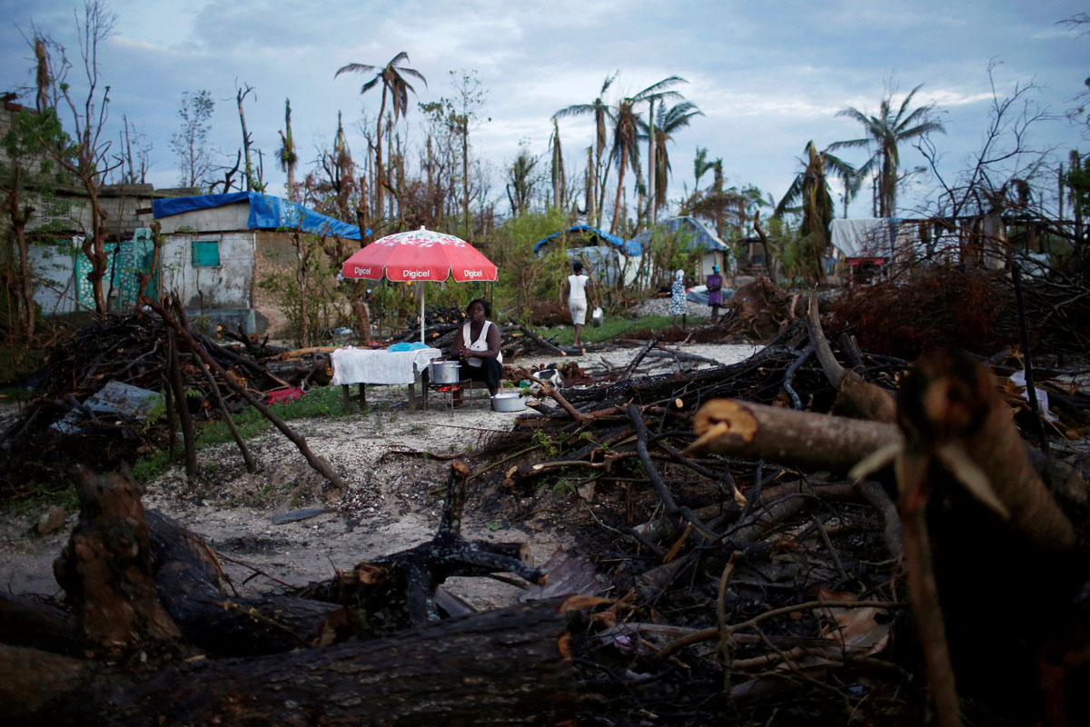 A food vendor waits for customers after Hurricane Matthew hit Jeremie