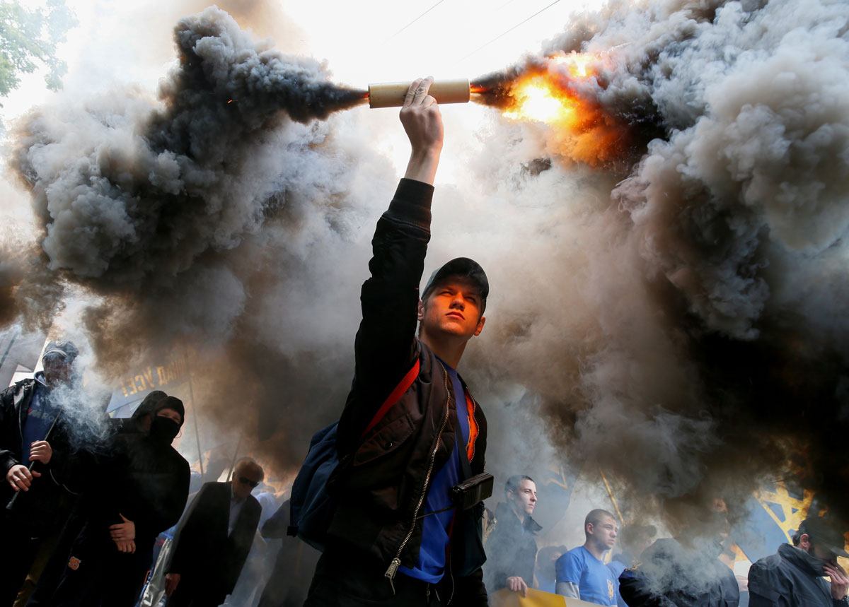 Members of the Ukrainian national guard "Azov" regiment and activists of the Azov civil corp take part in a protest against local elections in pro-Russian rebel-held areas of eastern Ukraine in Kiev