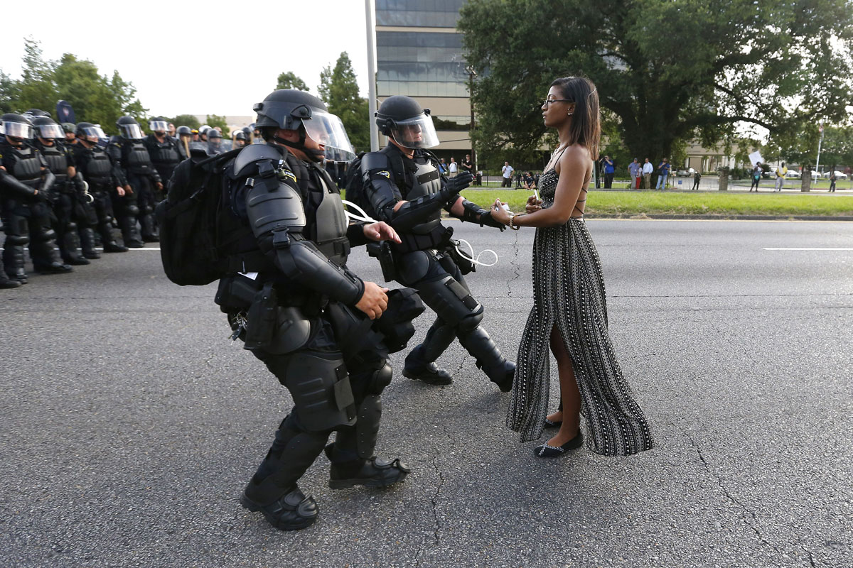 A demonstrator protesting the shooting death of Alton Sterling is detained by law enforcement near the headquarters of the Baton Rouge Police Department in Baton Rouge, Louisiana