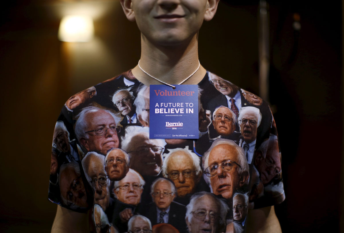 A volunteer at a U.S. Democratic presidential candidate Bernie Sanders' campaign event wears a shirt decorated with Sanders' image in Fort Dodge