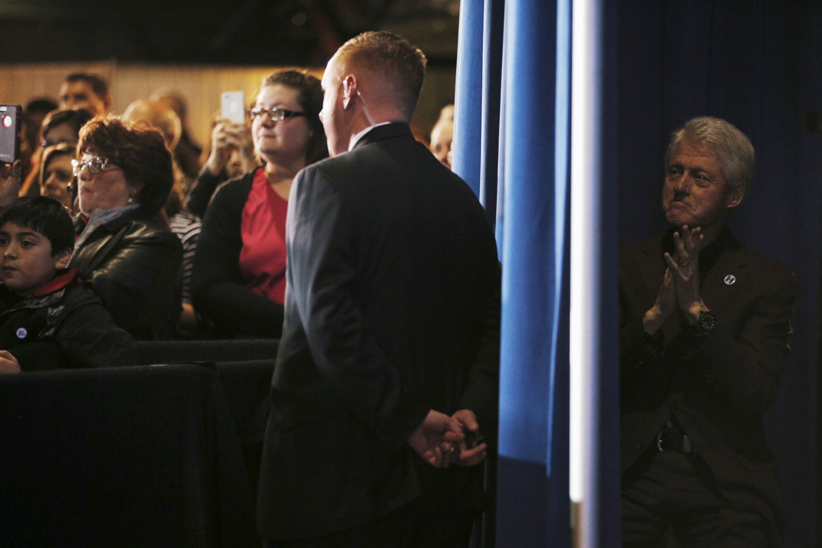 Former U.S. President Bill Clinton listens in the wings as his wife, U.S. Democratic presidential candidate Hillary Clinton, speaks at a campaign stop in Davenport, Iowa