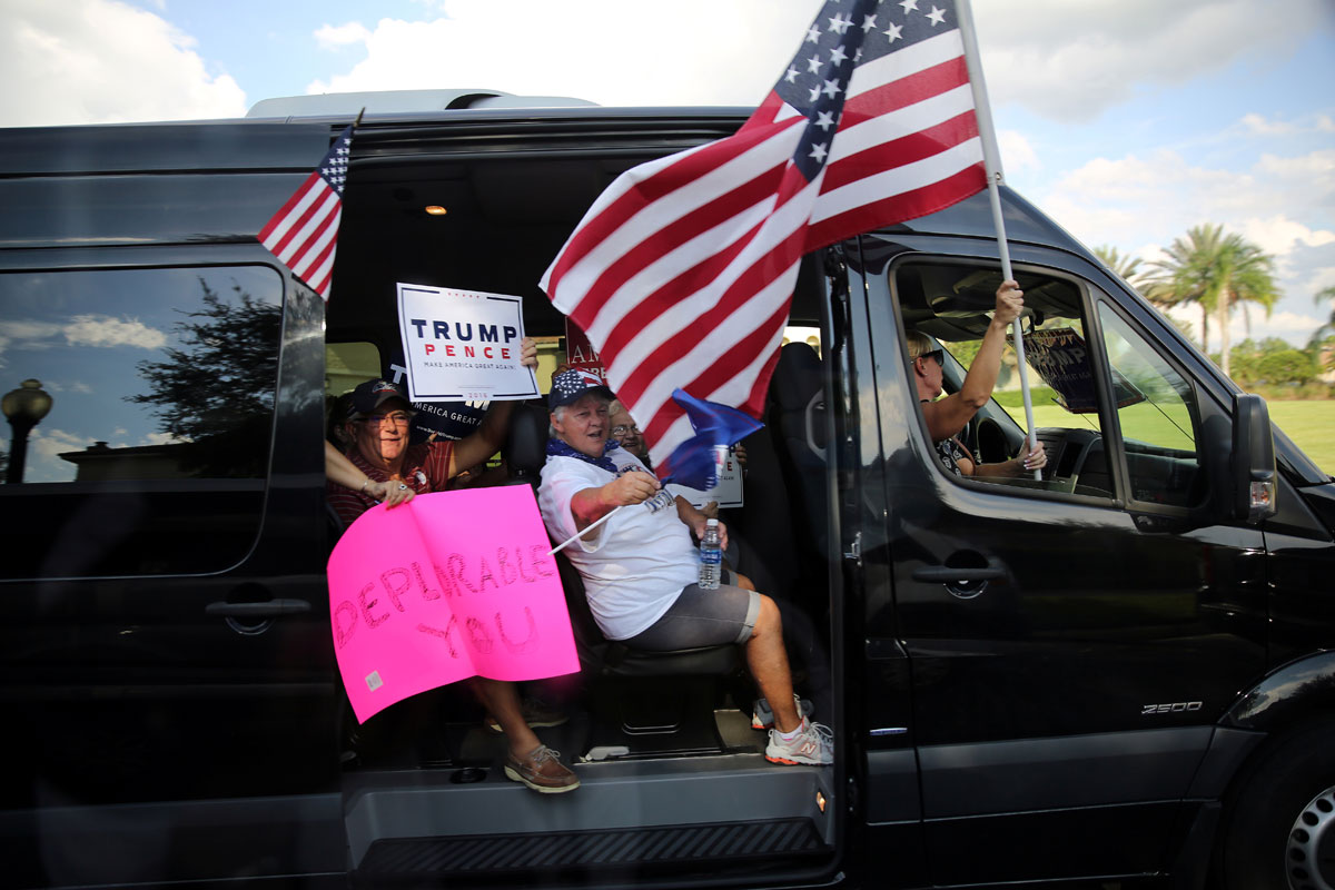 Republican presidential nominee Donald Trump supporters drive past the U.S. Democratic presidential candidate Hillary Clinton motorcade as she leaves a fundraiser event in Orlando, U.S. 