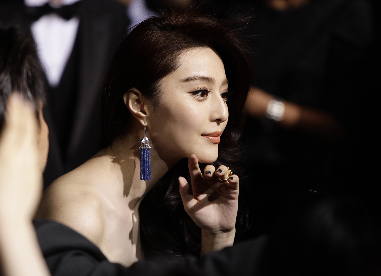 Chinese actress Fan Bingbing listens to the media as she arrives for the Giorgio Armani fashion show in Beijing