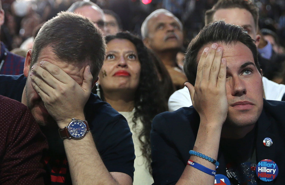 Supporters of Democratic presidential nominee Hillary Clinton watch and wait at her rally in New York